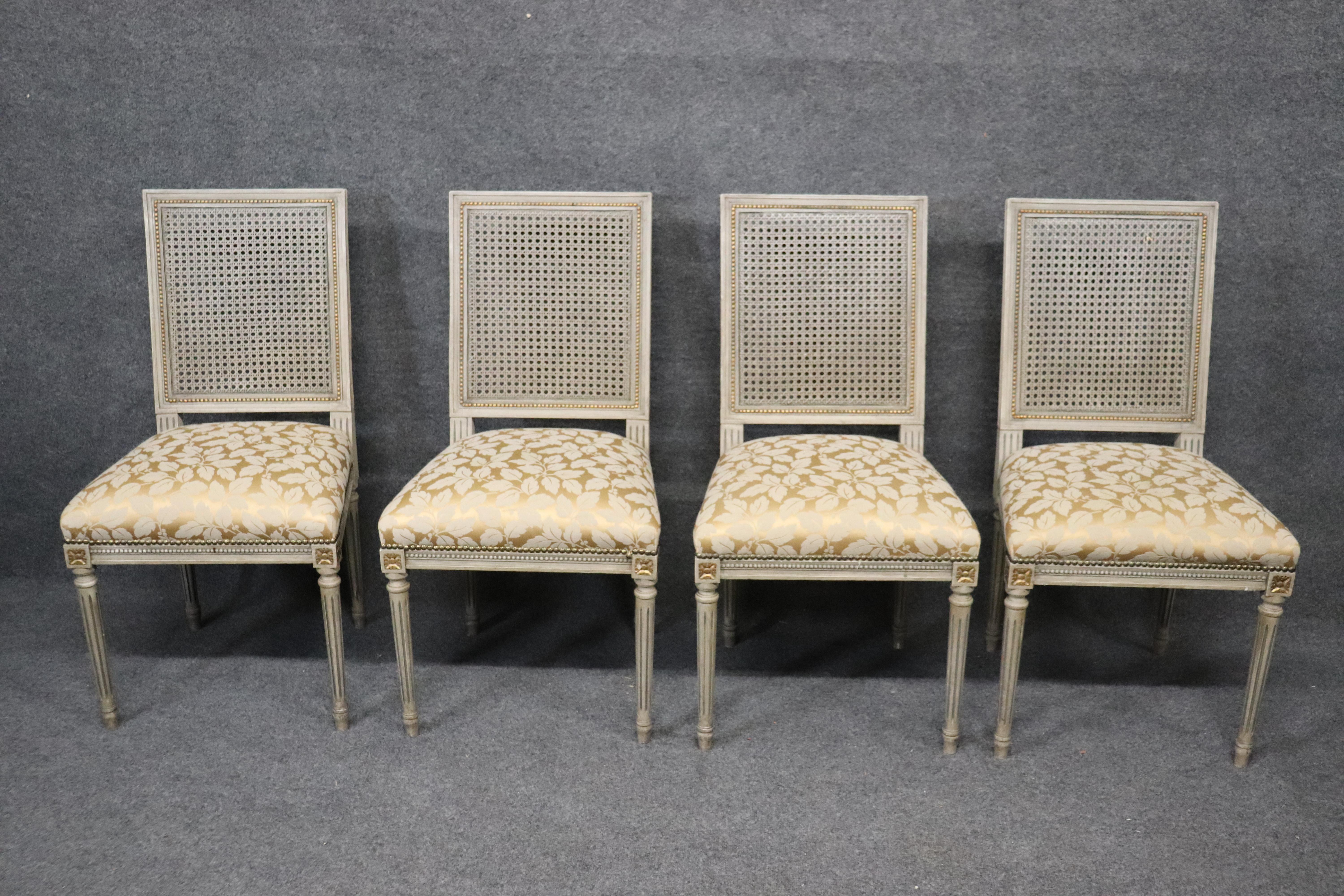This is a wonderful set of Maison Jansen style Louis XVI dining chairs. The set is in very good condition with good cane backs and beautifully painted frames and subtle gilt details. The chairs date to the 1920s and measure 37 tall x 19 wide x 20