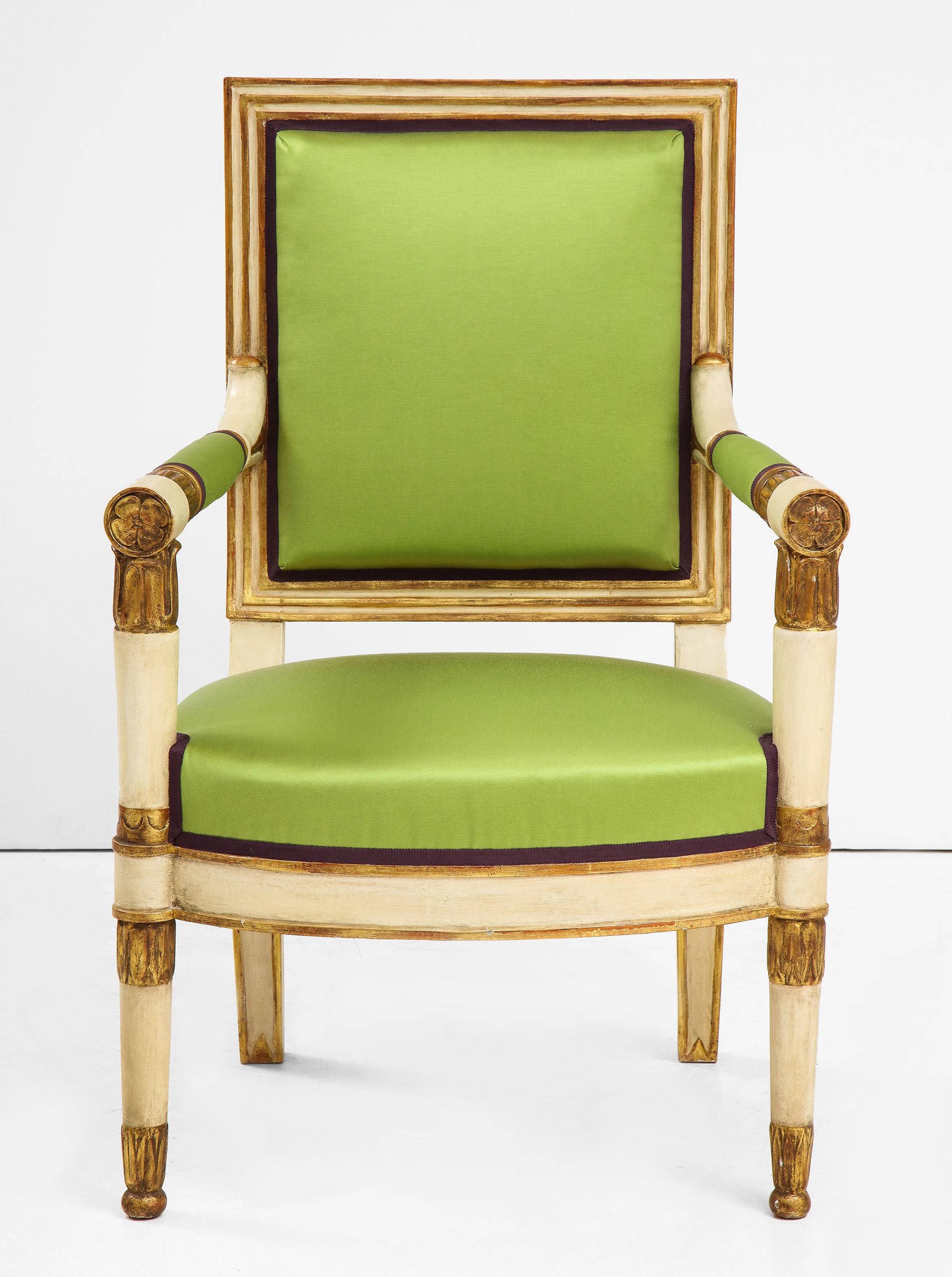 The painted and parcel gilt upholstered back flanked by upholstered round arms ending in gilt florets.  The bowed attached seat raised on white and parcel gilt legs ending in ball feet. 
4 Ams from 1810 
4 additional Arms from a later date.