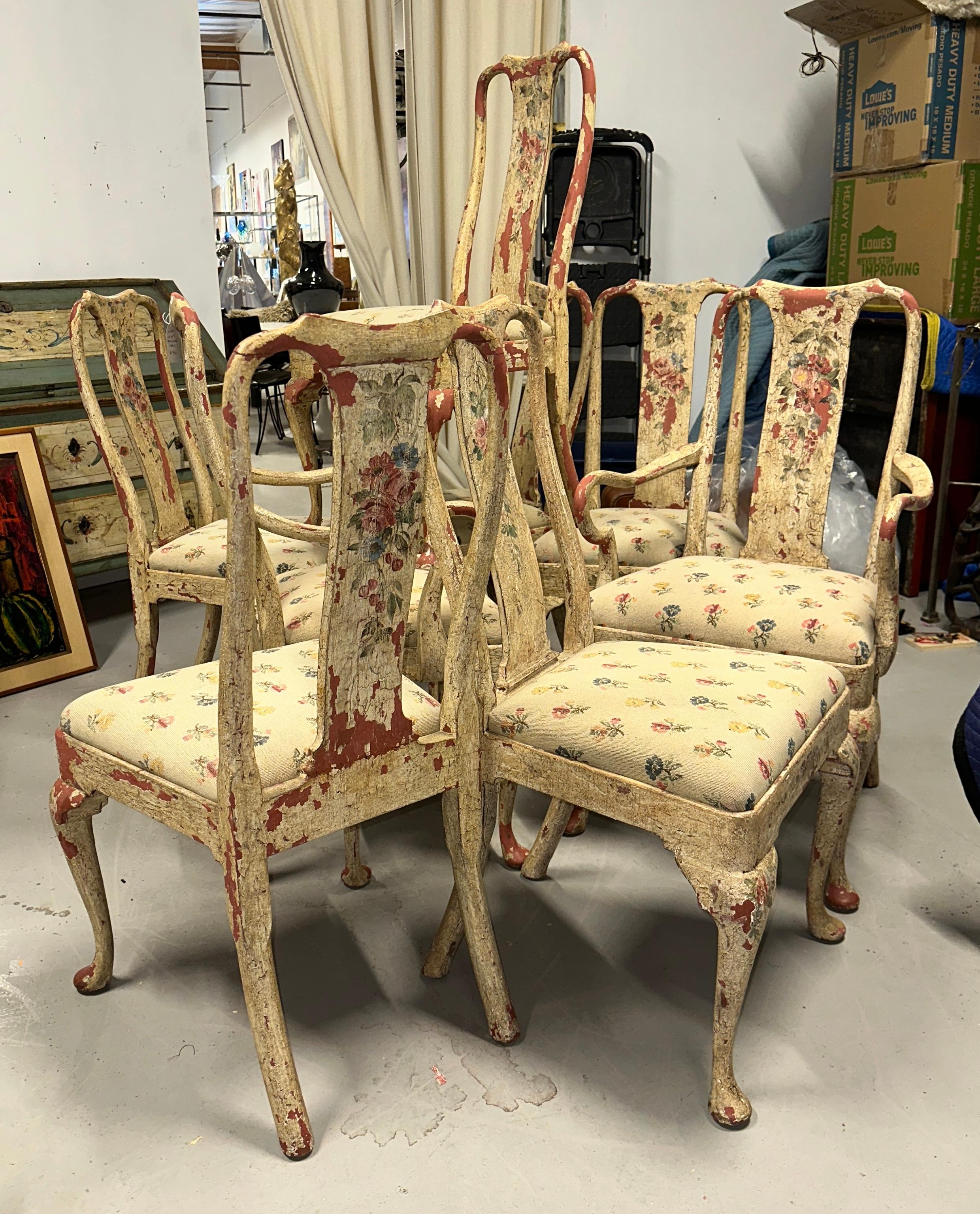 A wonderful set of 8 hand painted dining chairs with lovely needlepoint cushion seats in a floral pattern. There are 2 arm chairs and 6 side chairs. The paint is chipping all over to reveal a great shade of red underneath, perhaps the original