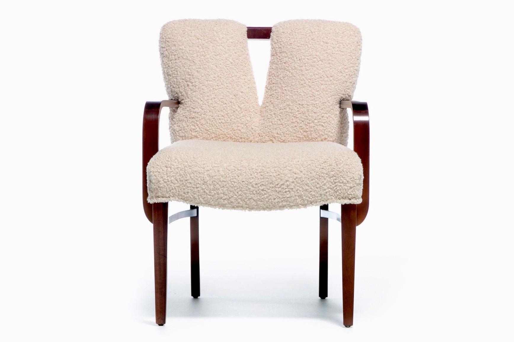 Exquisite set of eight freshly restained and reupholstered Paul Frankl Corset Back Armchairs in ivory white bouclé. Surprisingly practical and comfortable, the seat back cut out allows for ventilation and keeps your guests cool and comfortable