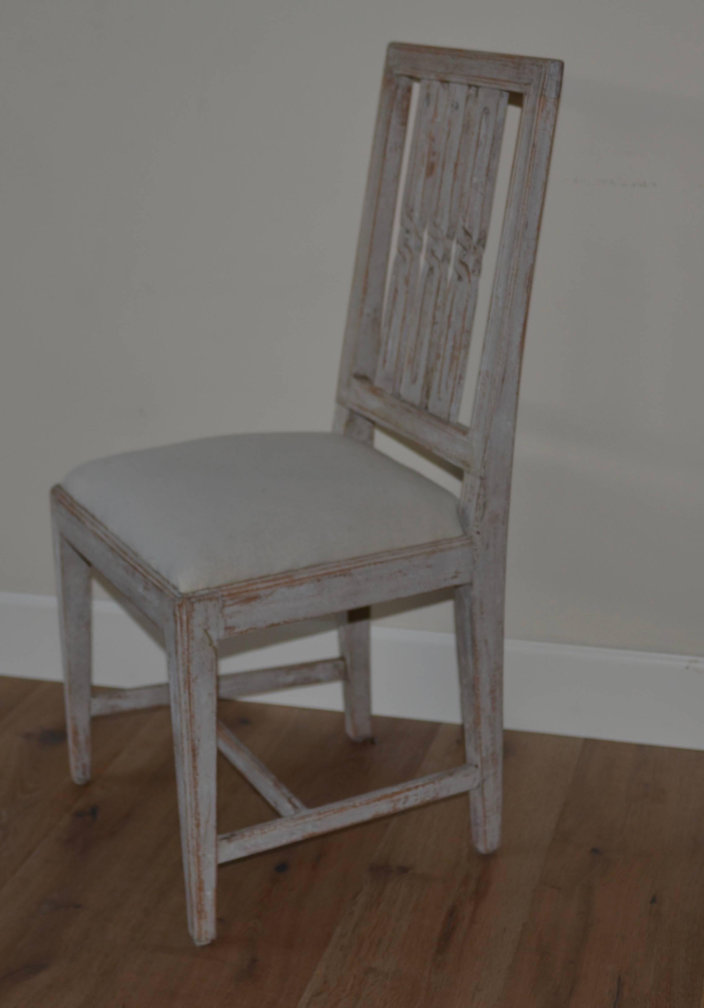Swedish set of eight period Gustavian dining chairs scraped down to the original Swedish grey/blue finish. Lovely open work geometrical backs with simple tapered legs. Covered in Swedish muslin. Fully restored and sturdy.