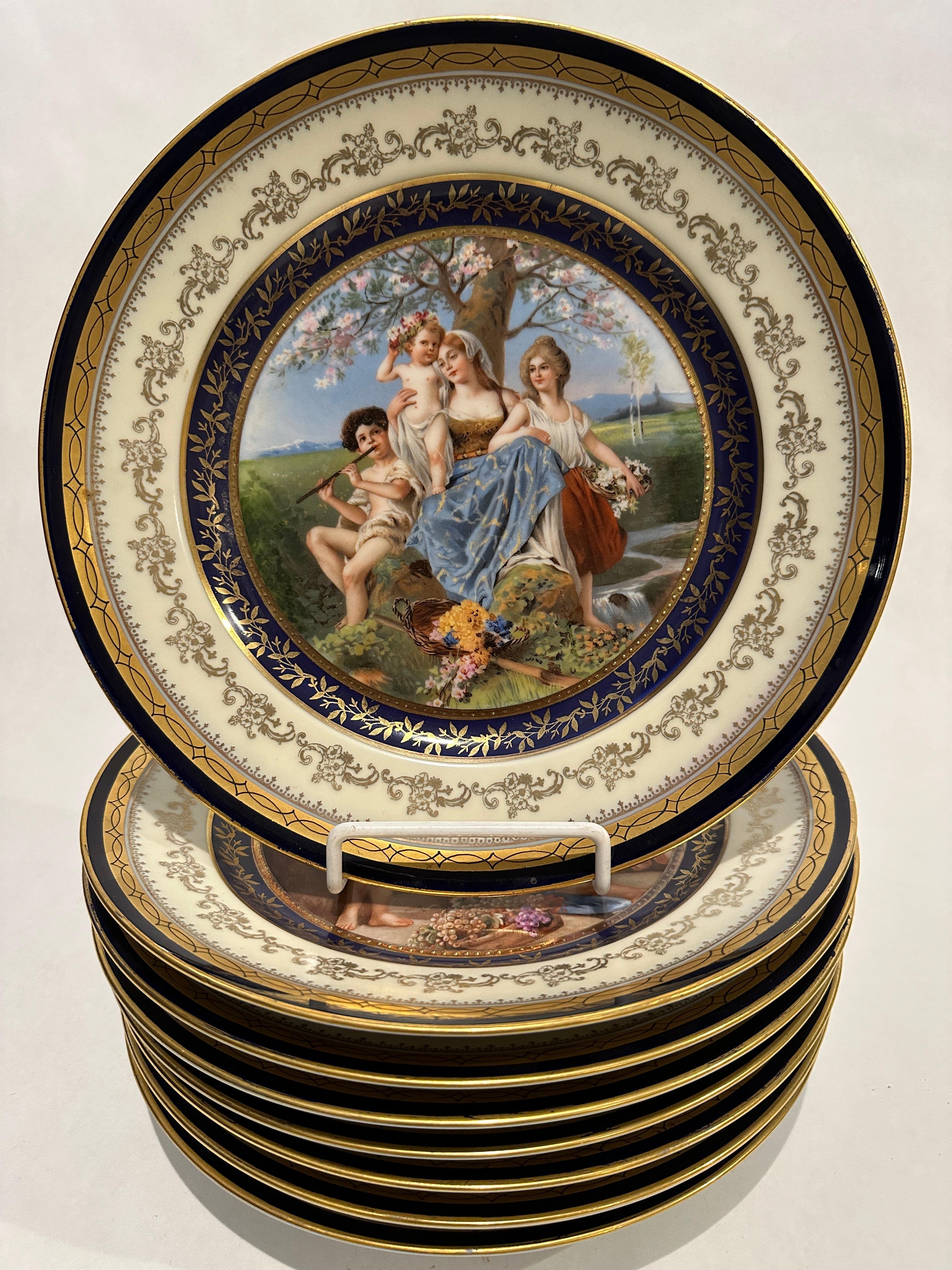 An elaborate set of 8 Continental porcelain hand painted cabinet plates with cobalt and gold borders. The plates measure 10.88 inches in diameter and depict 8 different allegorical scenes in vibrant colors. No breaks or repairs with minimal to no