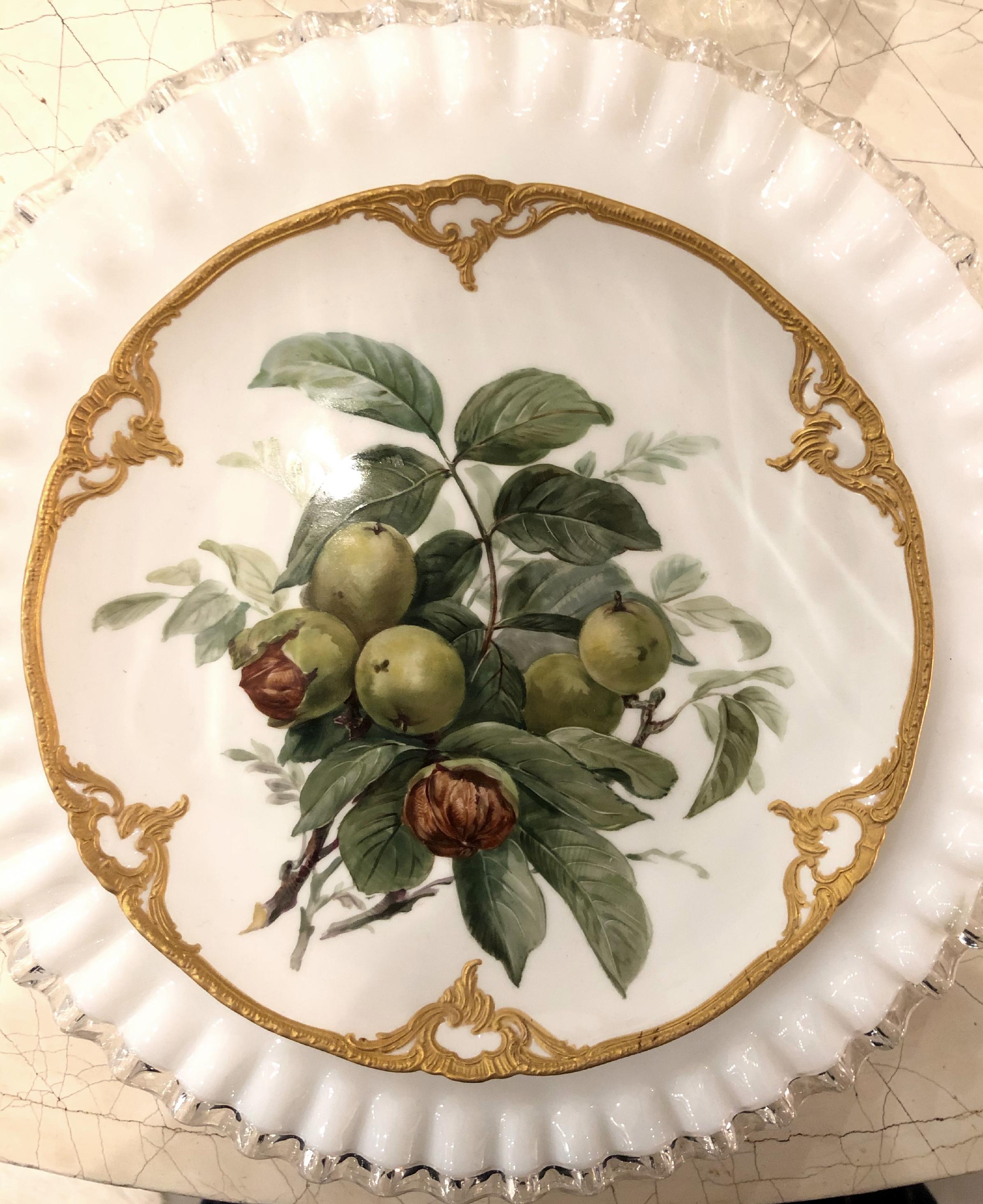 Set of eight beautiful hand-painted turn off the century porcelain plates depicting fruit with elaborate 14-karat gold detailing. The back of each is stamped 