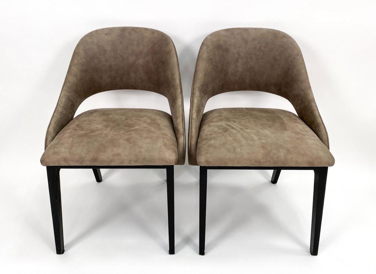 Set of eight sleek Post Modern suede and lacquered oak dining chairs in the manner of Eero Saarinen. The curved back of the chair slopes down around the side creating a wonderfully comfortable slipper, so to speak. The sides then slide under the