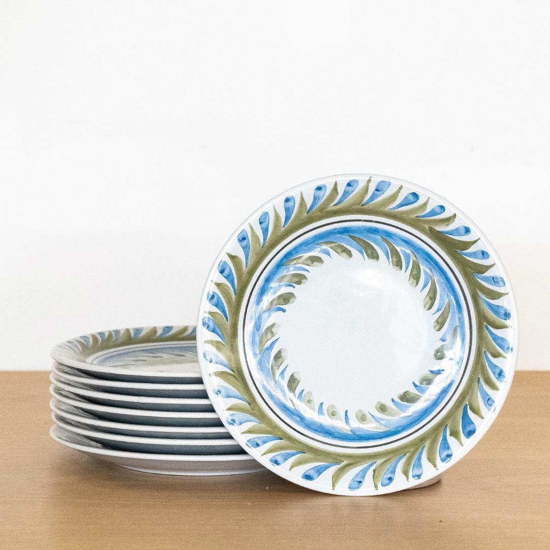 Incredible set of 8 painted plates by Roger Capron from France, 1950s. Beautiful hand painted blue and green leaf motif on slightly tinted blue ceramic plate. Signed on back.