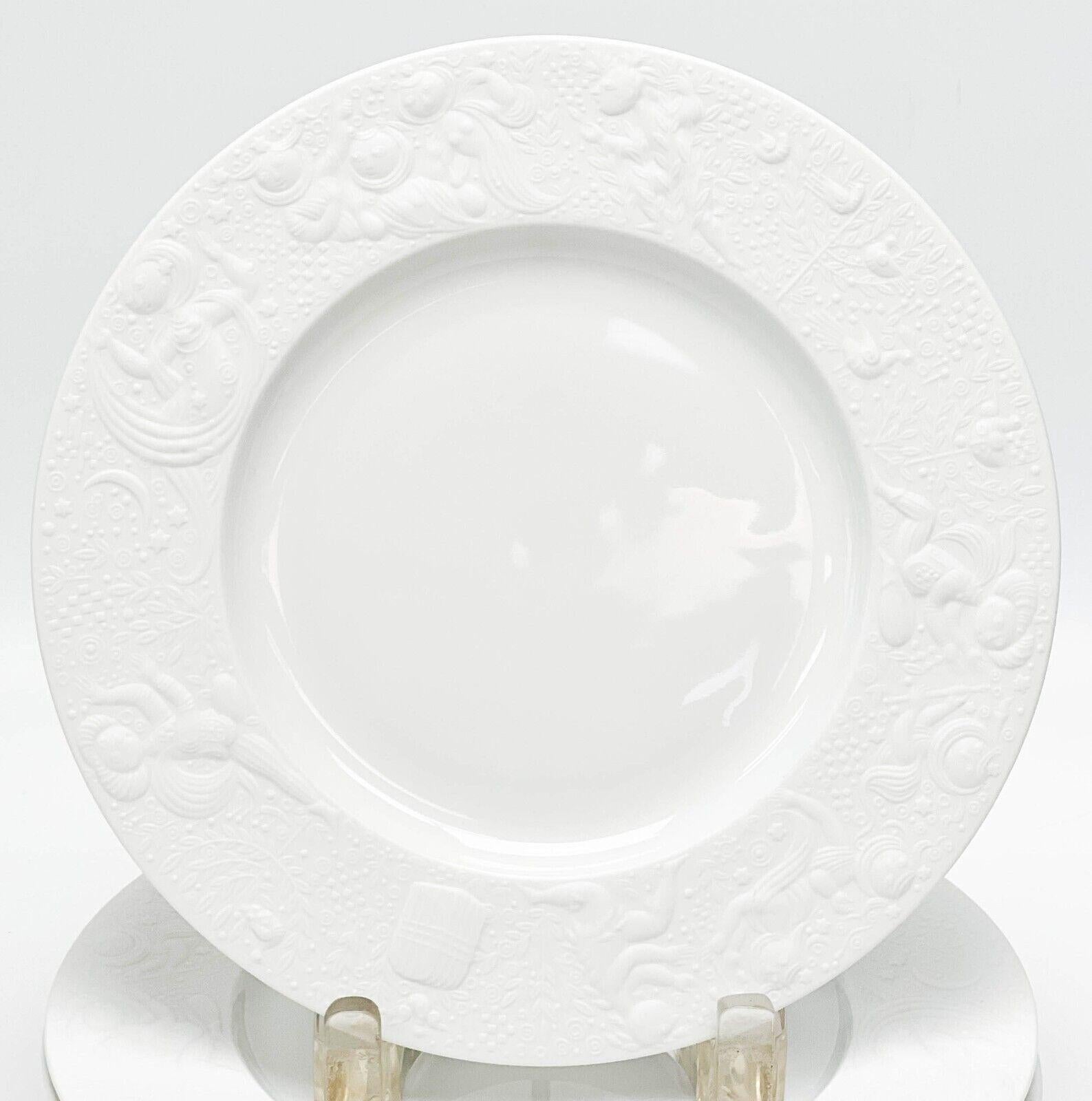 Set of 8 Rosenthal Germany porcelain salad plates in magic flute white.

White porcelain with embossed figures around the rim with a matte finish. Underside marked Rosenthal Germany, Bijorn Wiinblad and with various gold lettering to the underside
