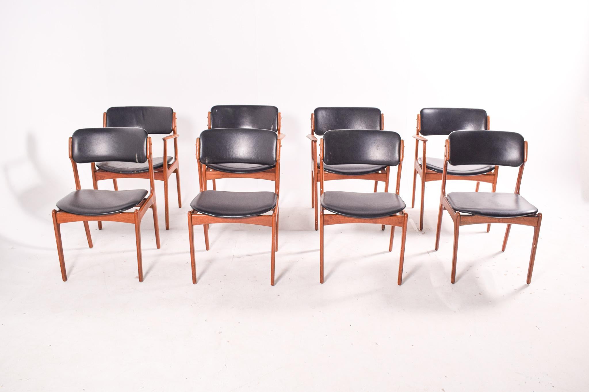 Very fine set of one of the iconic Danish dining chair designs. Model 49 by Erik Buch. Four chairs in teak with arms and 4 without. Dining chairs with floating seat make by Oddense Maskinsnedkeri. The chairs have a simple solid construction with