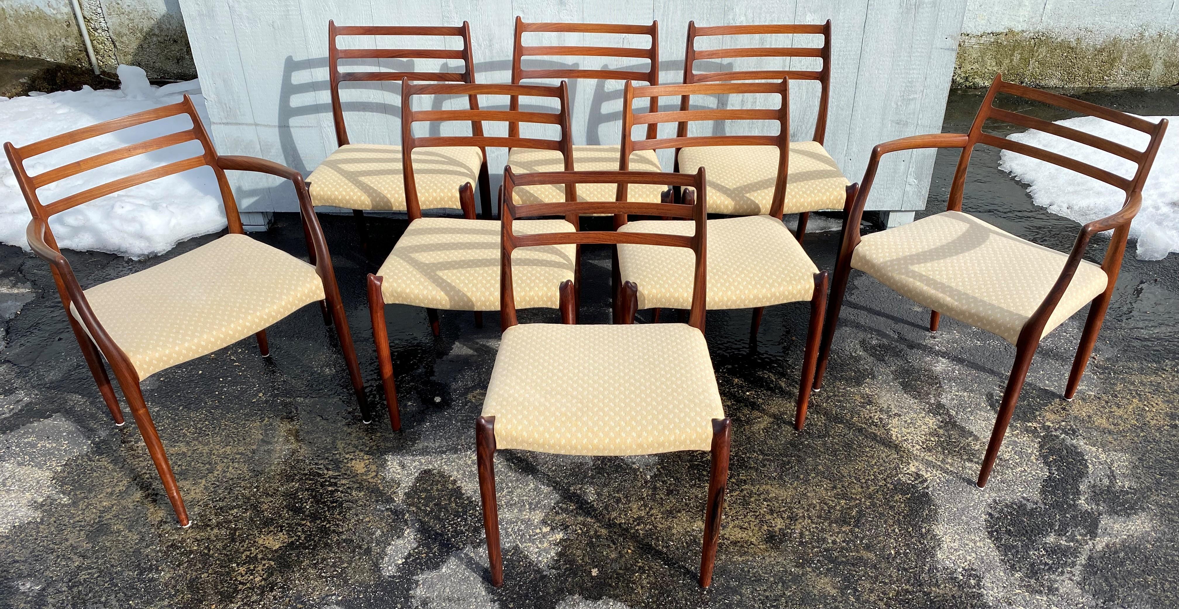 A Fine set of 8 Mid-Century Modern Scandinavian dining chairs, including six Model 78 side chairs and two Model 62 arm chairs, designed by Neils Otto Møller and produced by J.L. Møller Møbelfabrik. In very good overall condition, with minor surface