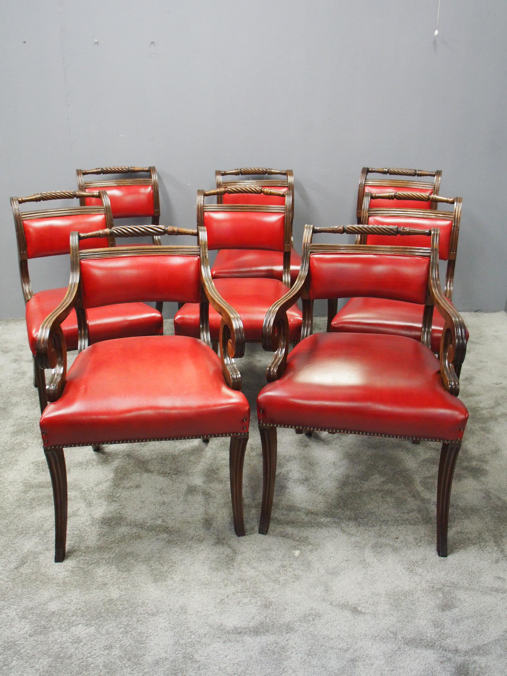 Set of 8 Scottish Regency mahogany dining chairs, in the manner of William Trotter of Edinburgh, circa 1810. Recently reupholstered in red hide, with shaped backs featuring a rope twist top rail and upholstered panel between shaped fluted uprights.