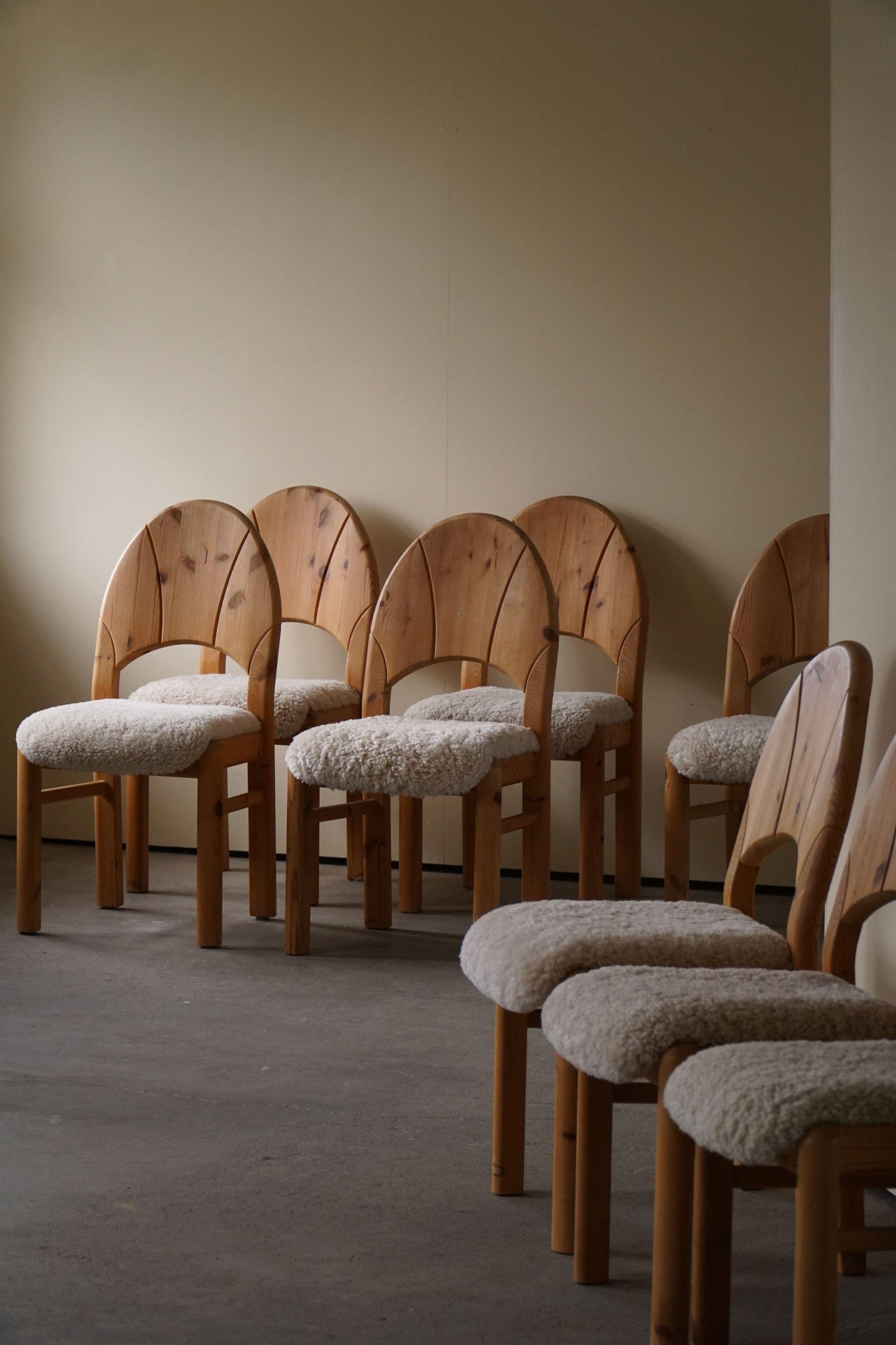 A neat set of 8 sculptural dining chairs in solid pine, reupholstered in great quality shearling lambswool. Made by a Danish cabinetmaker in 1970s. These chairs have a really strong impression that pairs well with many types of interior styles. A