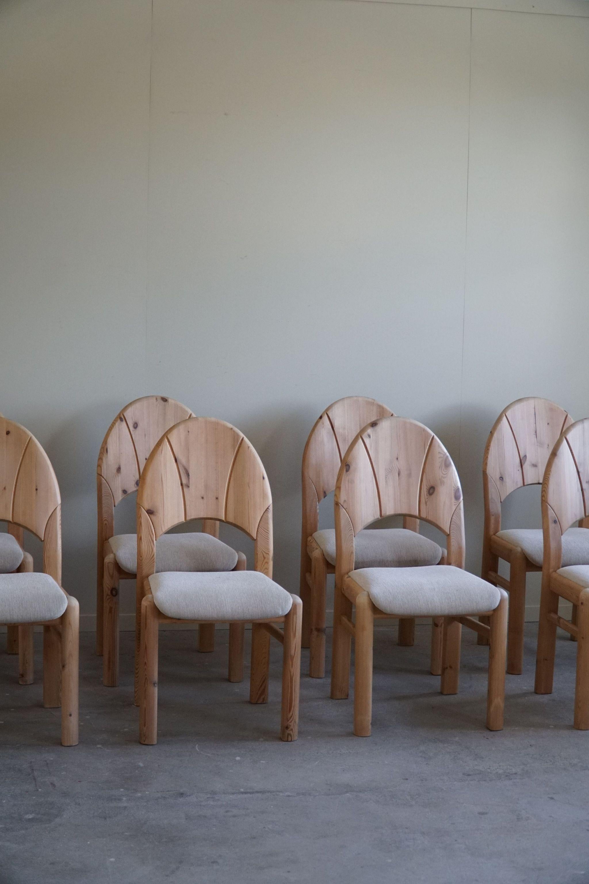 A neat set of 8 sculptural dining chairs in solid pine, upholstered in a fine quality wool. Made by a Danish cabinetmaker in the 1970s. These chairs have a really strong impression that pairs well with many types of interior styles. A Modern,