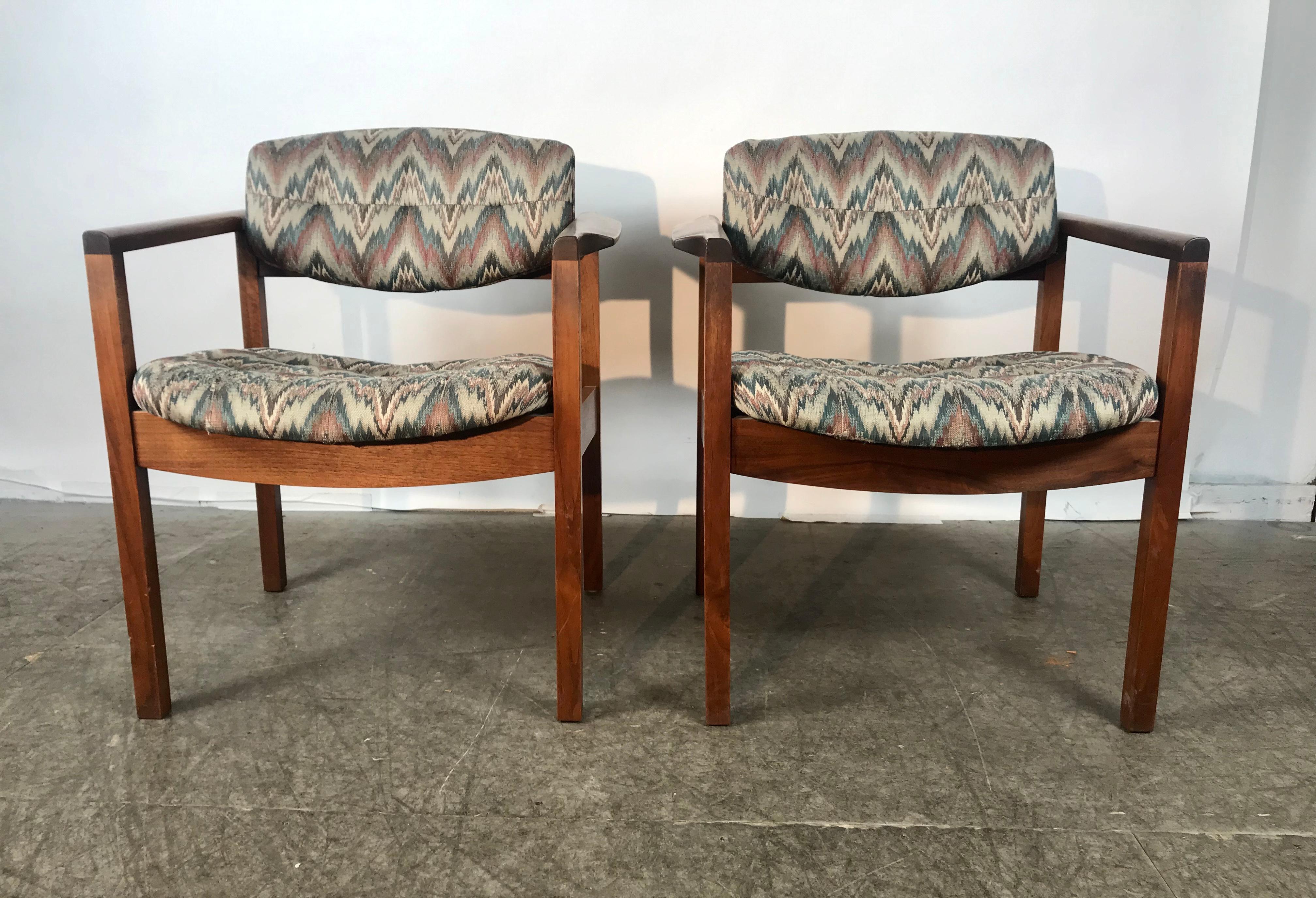 Matched set of 8 Mid-Century Modern sculptural walnut lounge chairs. Manufactured by, Gunlock. Superior quality and construction. Extremely comfortable, wonderful style and design. Appear to have been reupholstered in the 1980s with classic flame