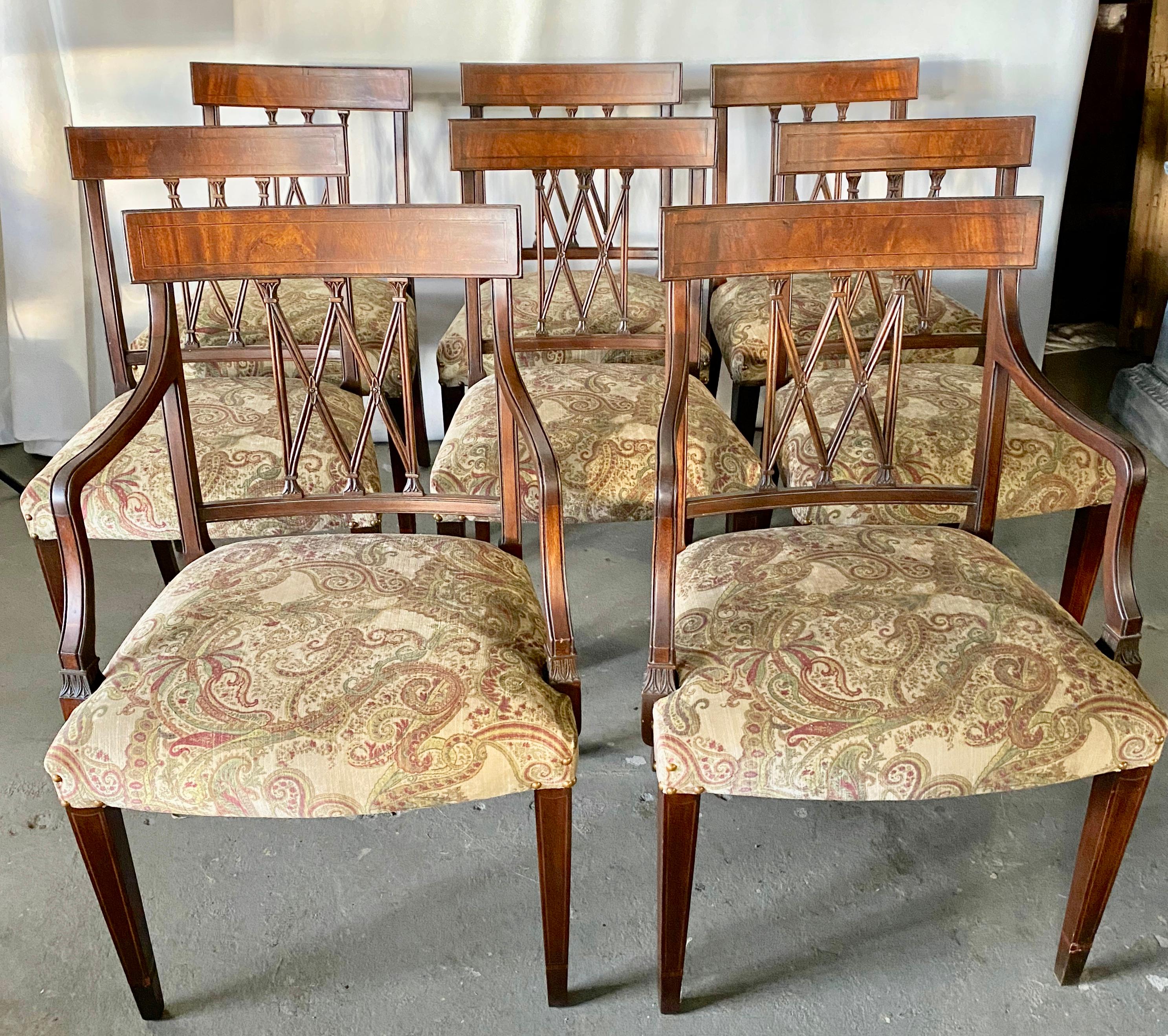 A very elegant set of eight Sheraton Revival mahogany dining chairs, each with beautiful carved X-frame backs. The seats are upholstered in a paisley pattern print, raised on tapering legs. The set consists of 2 arm chairs and 6 side chairs.
Arm