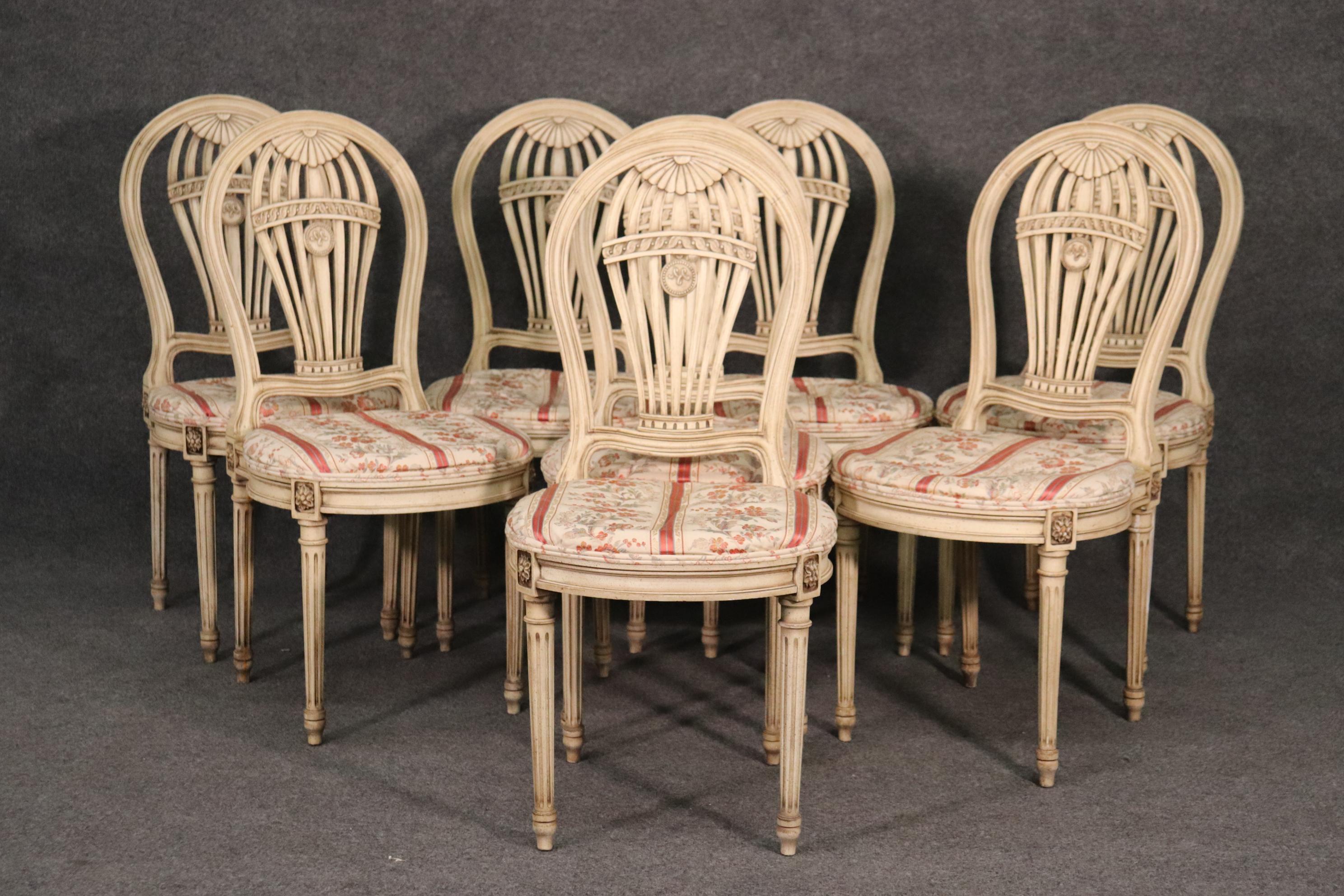 This is a gorgeous et of signed Maison Jansen dining chairs in the classic ballon back design with a beautiful antique white painted finish. The chairs measure 37 tall x 18 wide x 21 deep and the seat height is 18 inches tall. These chairs are
