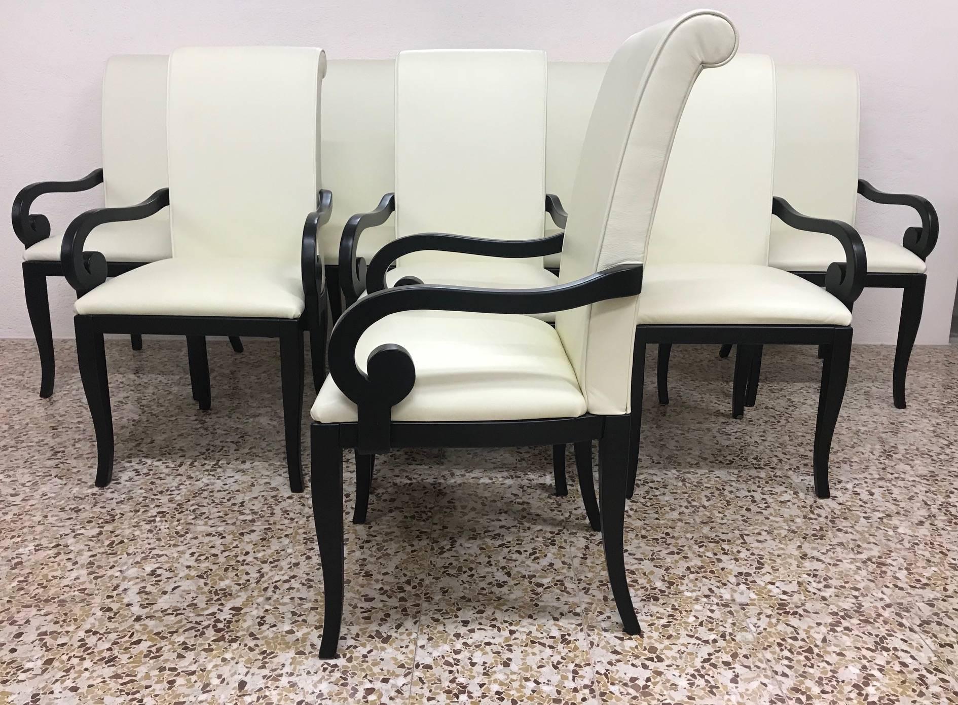 Set of six Art Deco inspired dining chairs, upholstered in fine ivory Italian leather.
The structure is made of black lacquered wood.