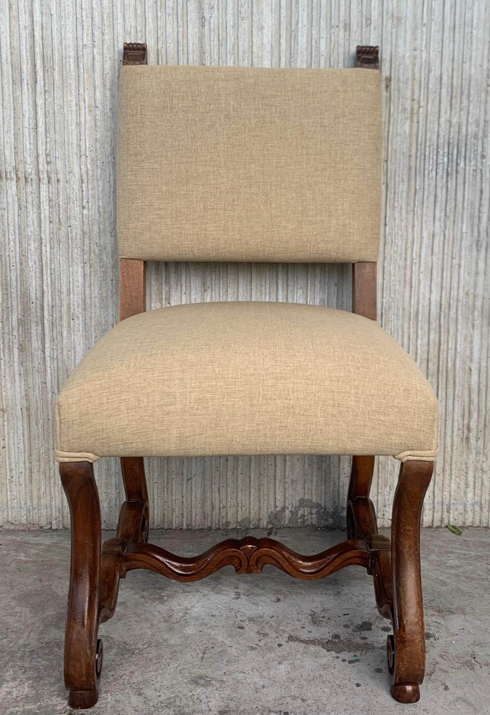 Set of 14 Spanish carved walnut dining chairs with upholstered seat and back.