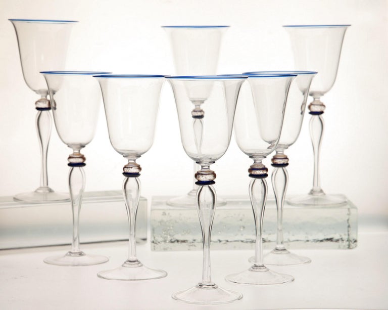 Elegant set of 8 stemmed glass from Cenedese.
The stem is blown glass rather than solid glass, resulting in a tall and thin cup. There is a fine cobalt rim at the mouth, a cobalt separator and gold leaf at the neck.

Exquisite manufacturing. 

The