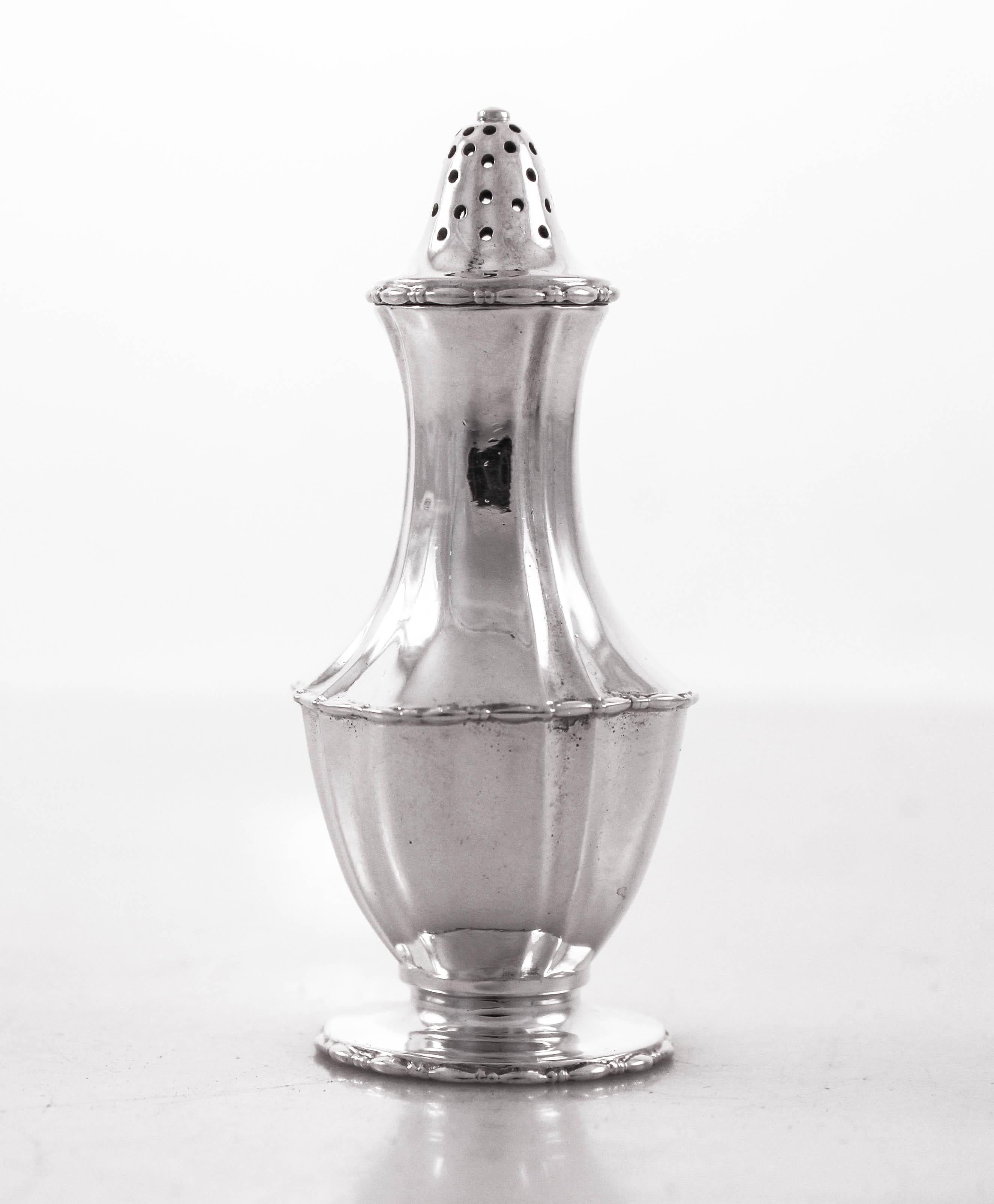 We are offering a set of eight sterling silver salt and pepper shakers. Made by the world renowned Tiffany & Co. in the 1940s. Sophisticated and elegant, each one has a scalloped waist and elongated neck. Beautifully made and signed by Tiffany.