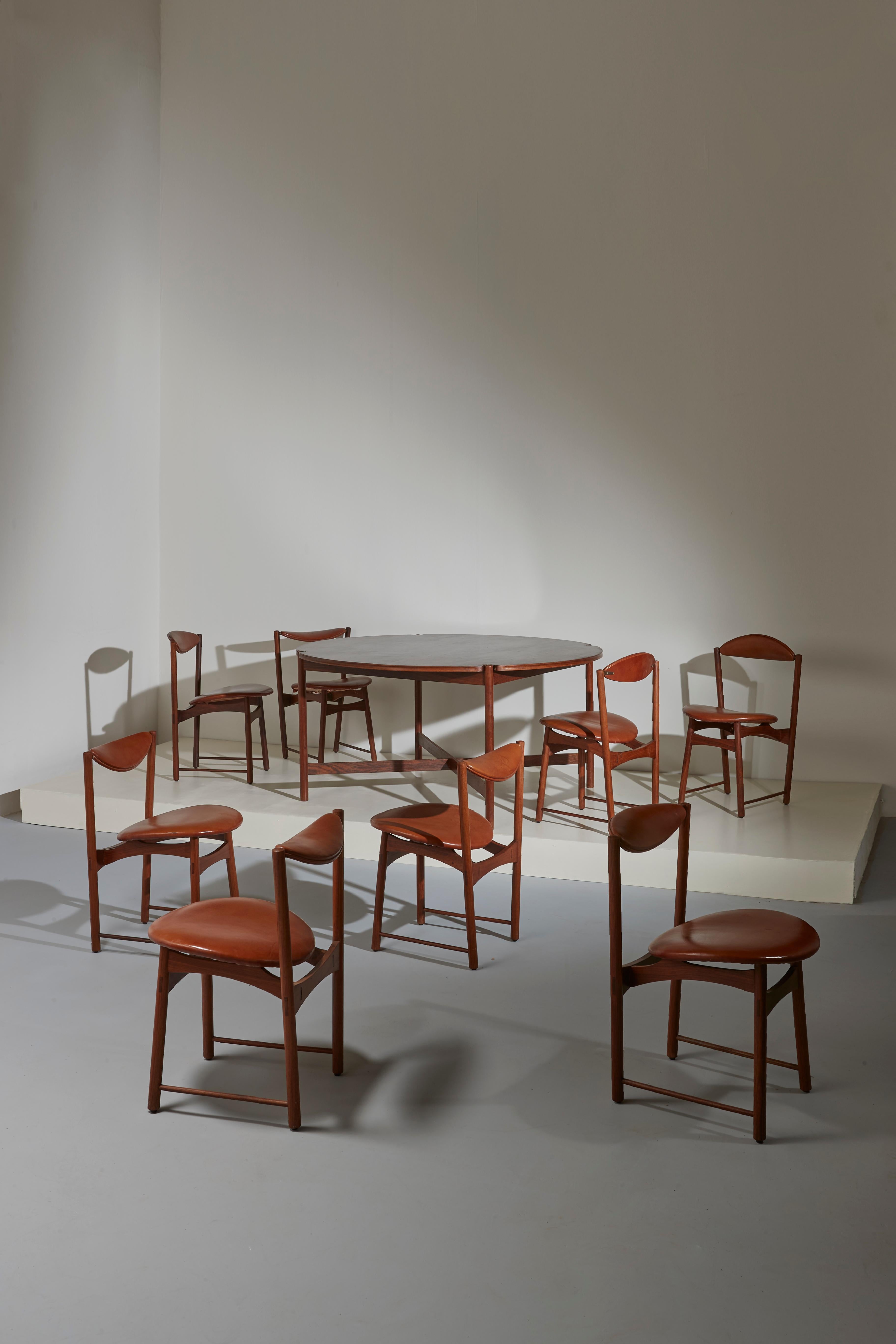 A very particular and beautiful set of eight dining chairs with tilting backrests and slanting legs. A perfect set if you are looking for chairs from the Mid-Century Modern period but that can be unique, different: yours.

Made in teak and reddish