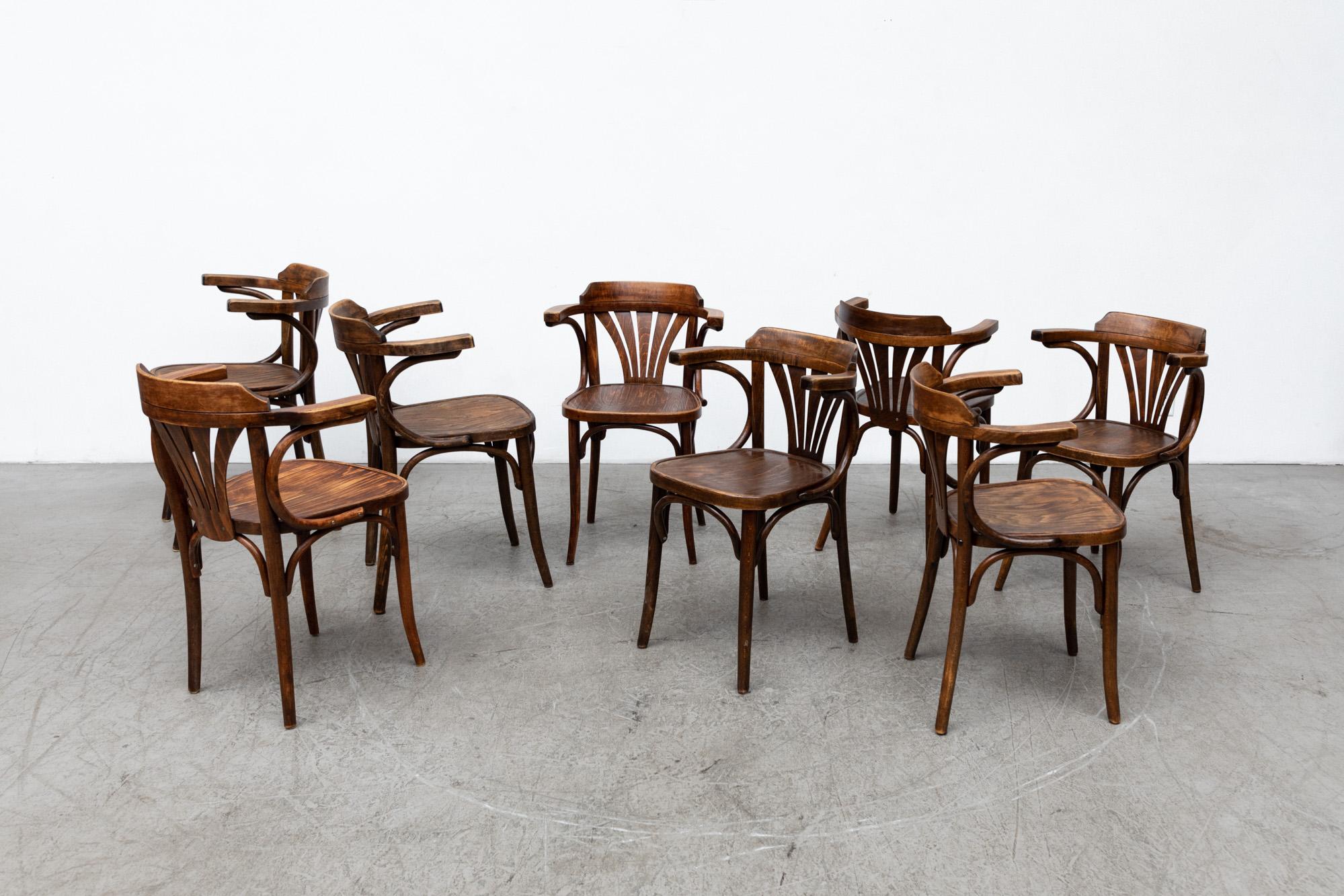 Set of 8 Thonet Style Cherry Toned Bentwood Bistro chairs by Drevounia, 1950's. Lightly refinished, in very original condition with heavy patina and wear. Wear is consistent with age and use. Set price.