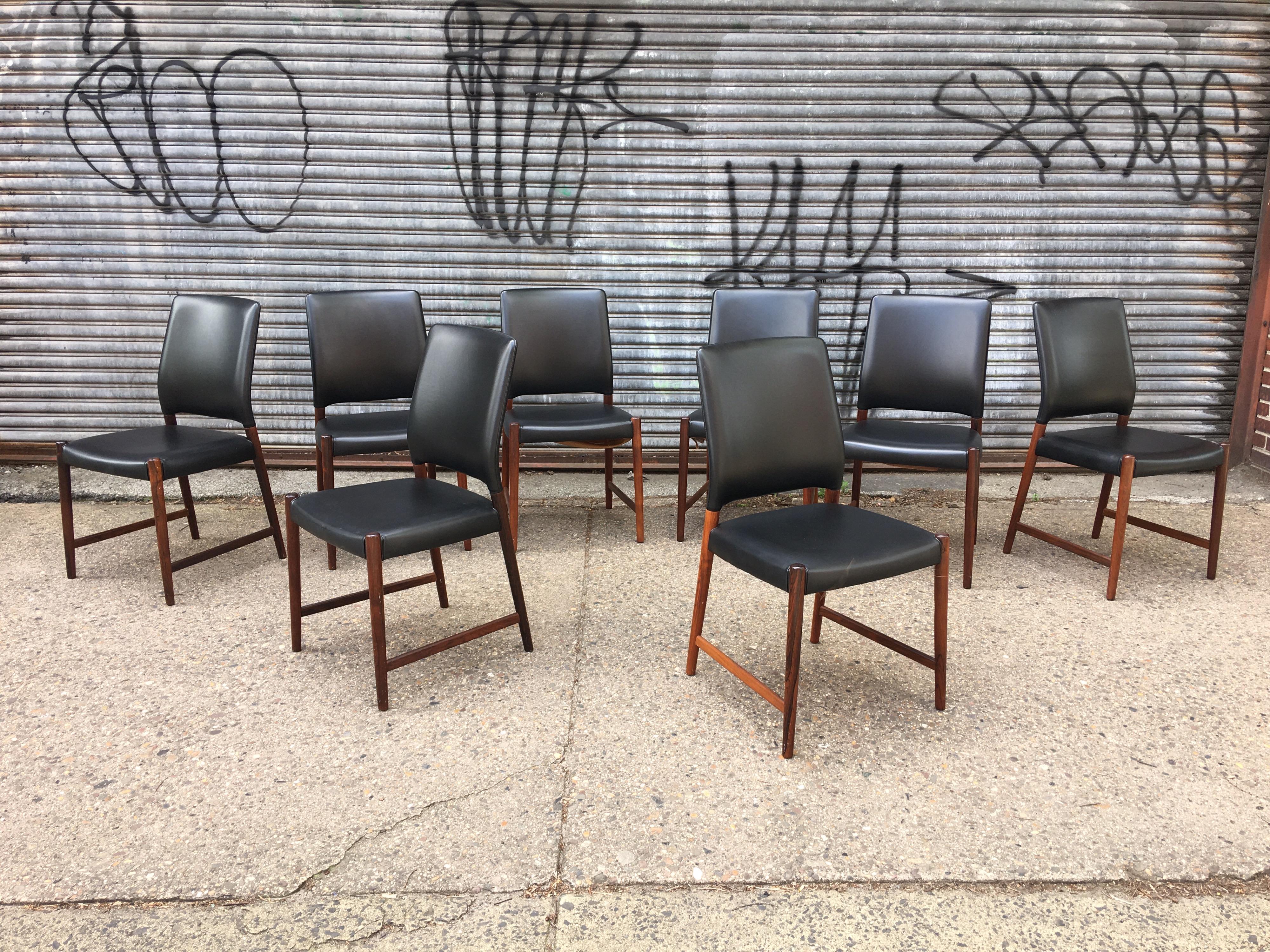 Nice set of 8 Torbjorn Afdal rosewood dining chairs in their original black vinyl. Each chair has Norway stamped on the underside. Often seen in Teak these Rosewood models are amazing with outstanding graining! Solid and comfortable! Nice to find a