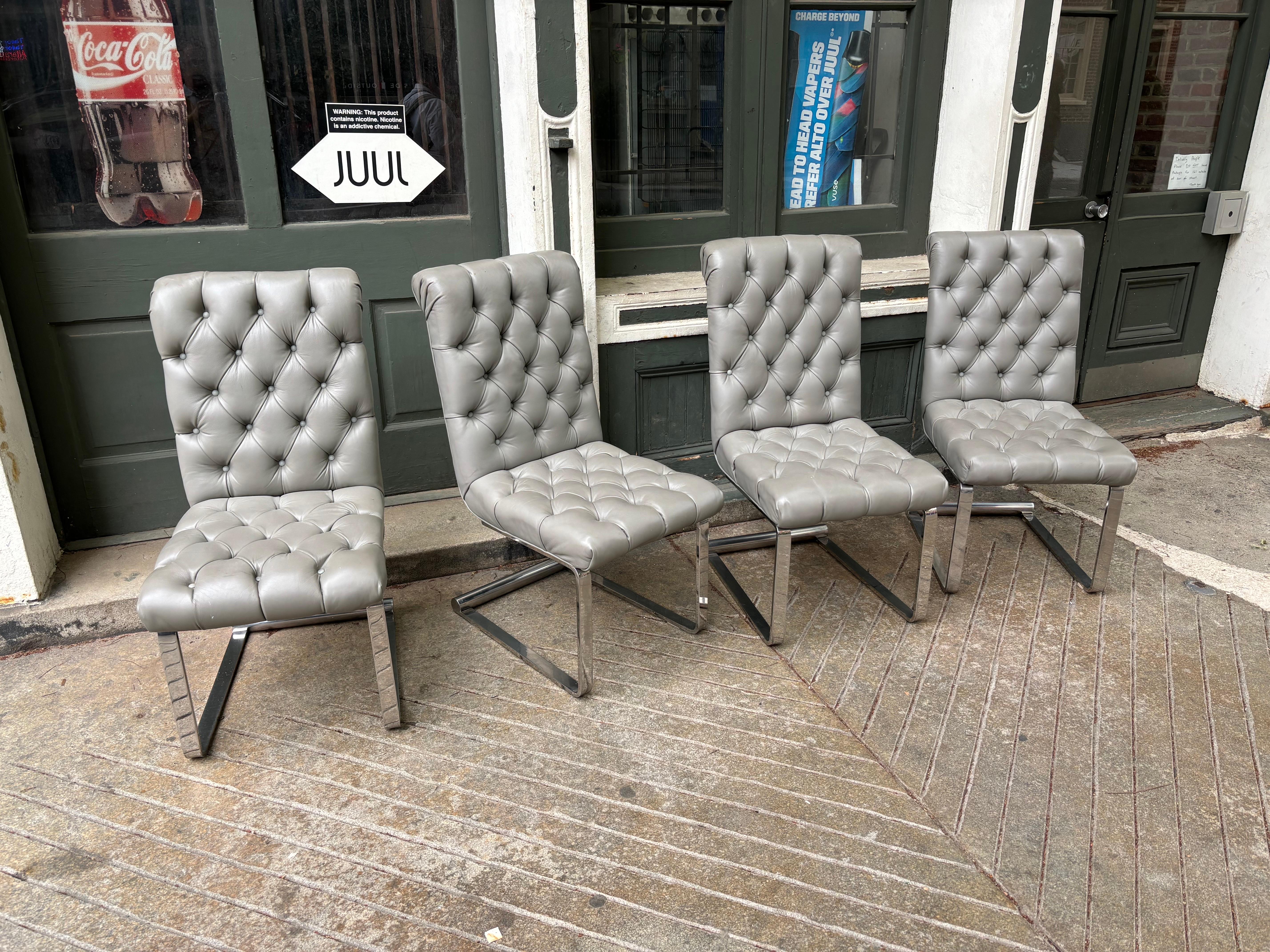 Set of 8 Tufted Gray Leather Cantilevered Dining Chairs.  Reupholstered about 15 years ago.  Nice Large Size Comfortable Dining Chairs.  Leather in good shape!  Chairs have a slight flex when you sit which adds a level of comfort.
