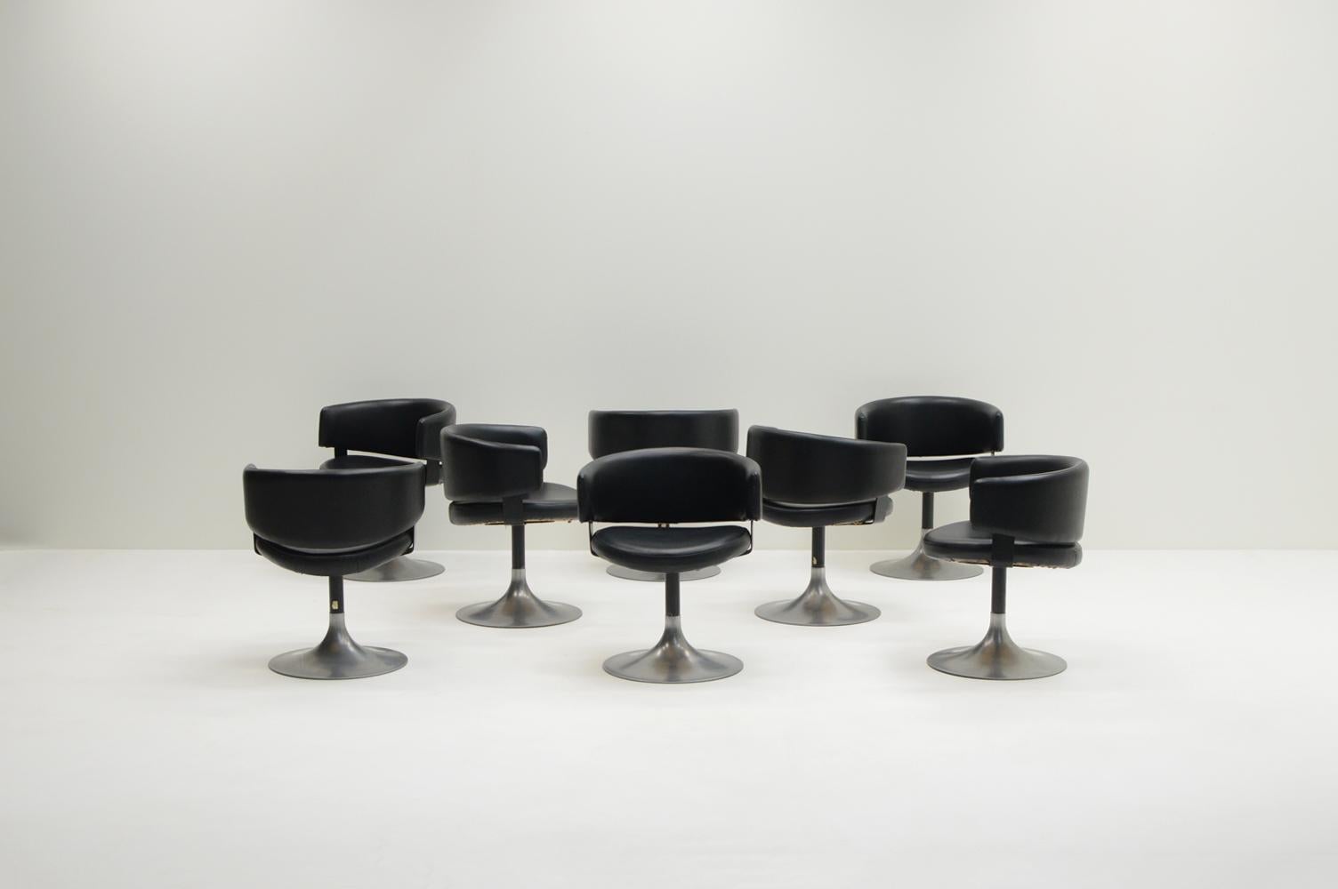 Set of 8 tulip chairs by Pizzi arredamenti, 1970s Italy. Aluminum and steel base with black faux leather seat and back. Elegant round back that also functions as arm rest. The tulip base has a nice patina. Due to the height (68cm) the chairs fit