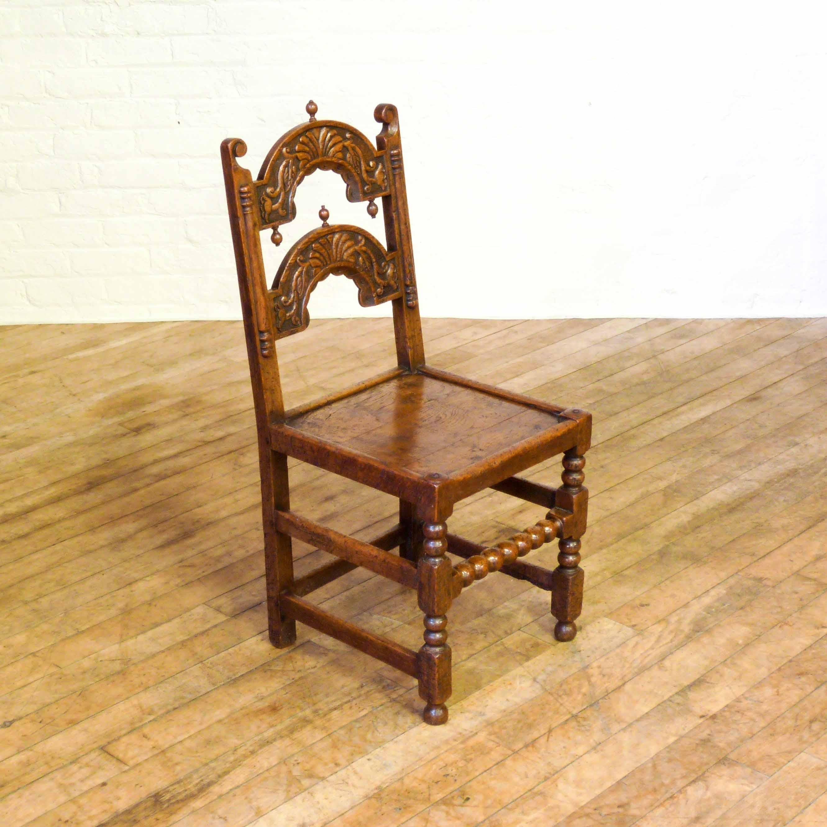 A fine antique set of eight oak Derbyshire style of chairs. This set is slightly earlier than the typical 1920s reproductions with the use of older timbers on the seats. Given a distressed look when made these chairs are full of character and are