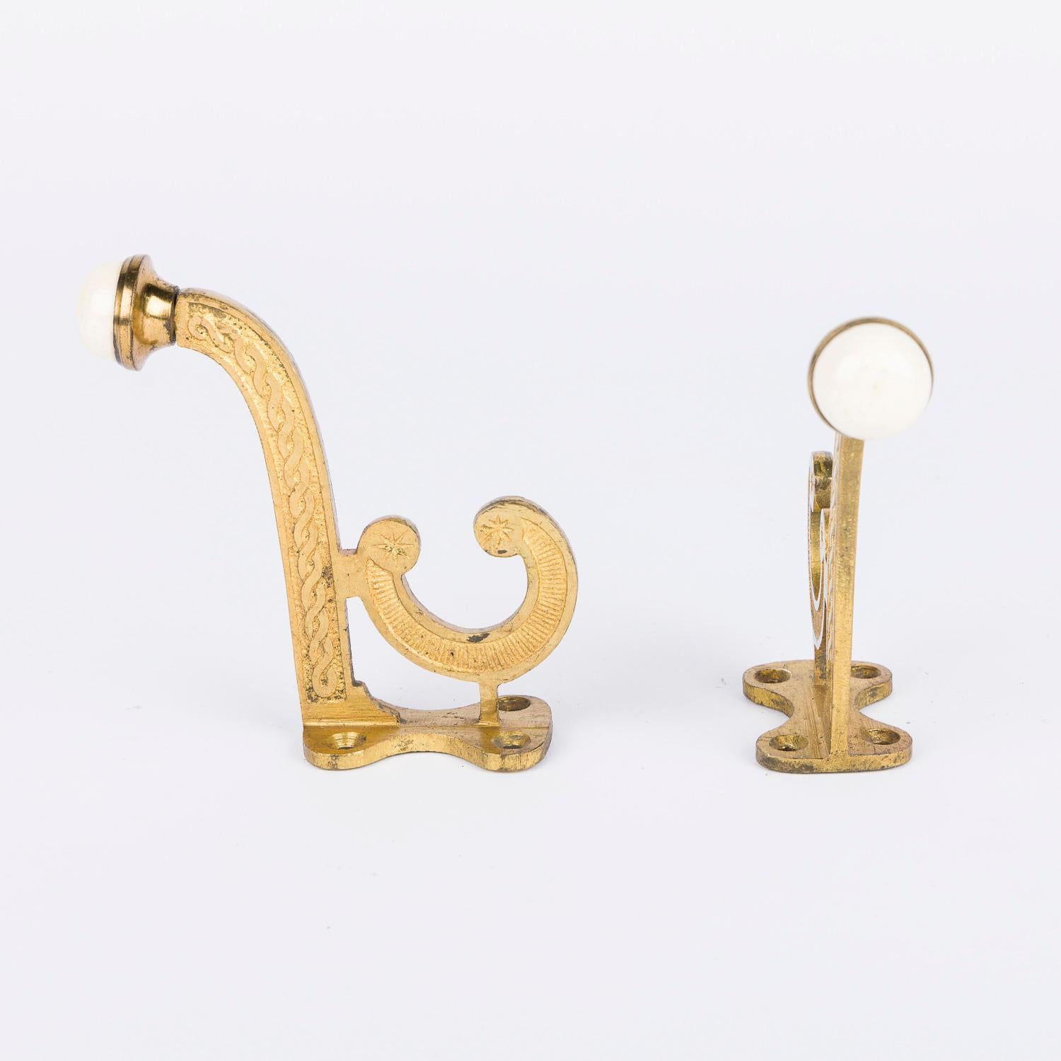 English Set of 8 Victorian gilt brass hooks with white porcelain finials. For Sale