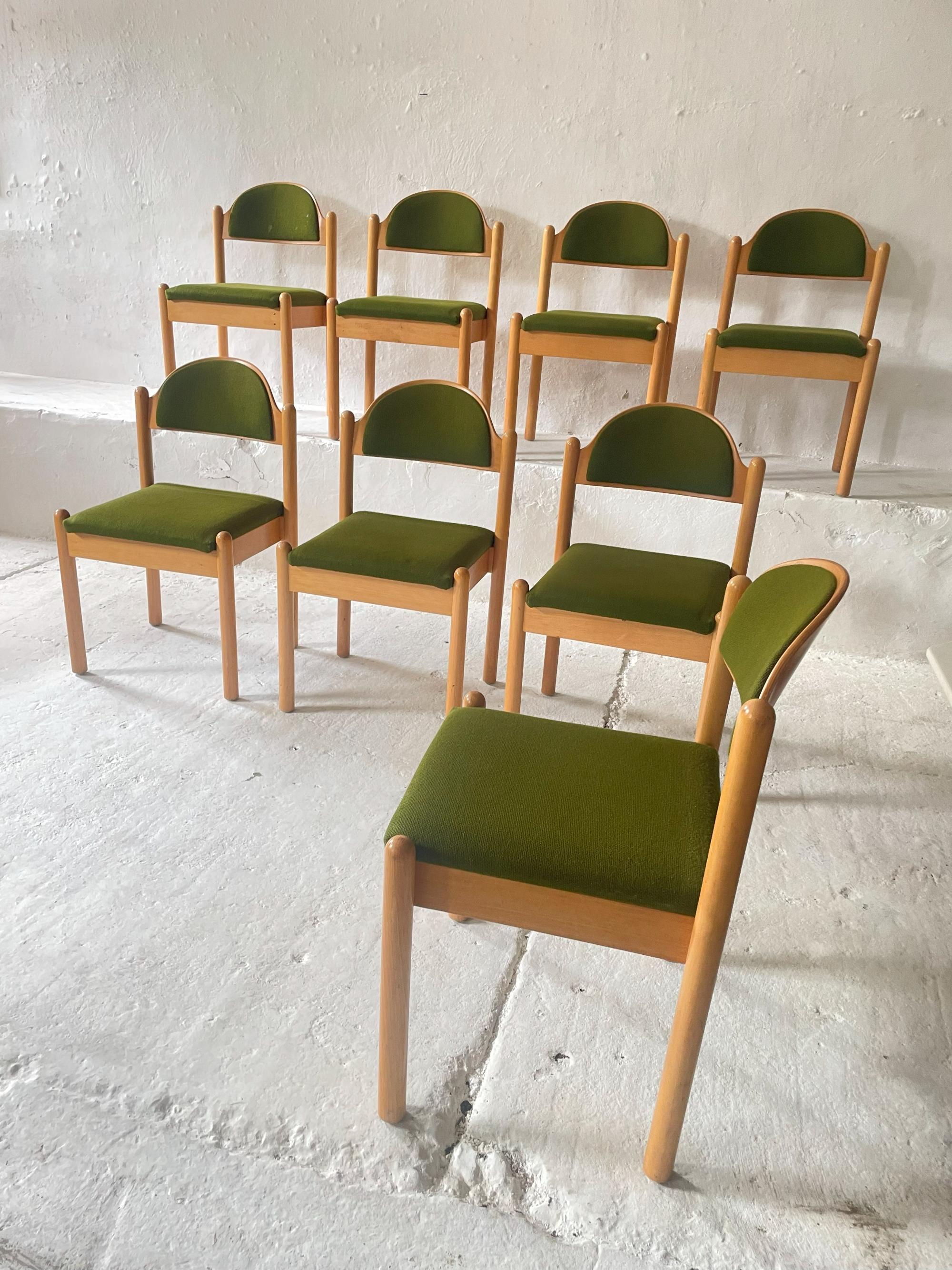 This elegant set of eight vintage dining chairs dates back to the 1970s and was crafted in Germany from high-quality beech wood. The chairs feature their original upholstery, retaining authentic character and charm. Their clean, timeless design