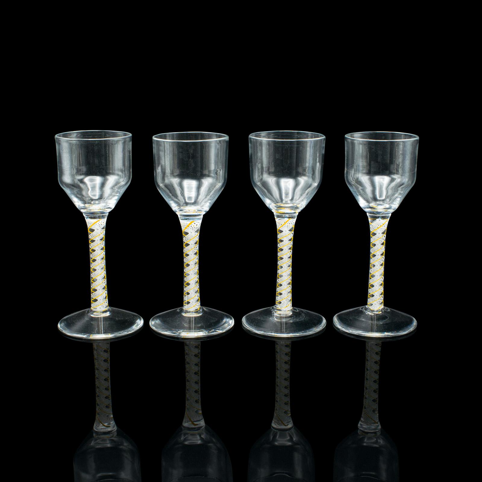 This is a set of 8 vintage aperitif glasses. An English, twist stem spirit or wine glass, dating to the late 20th century.

Pour an aperitif in these delightful glasses, ideal as a complement to an amuse bouche
Displaying a desirable aged patina,