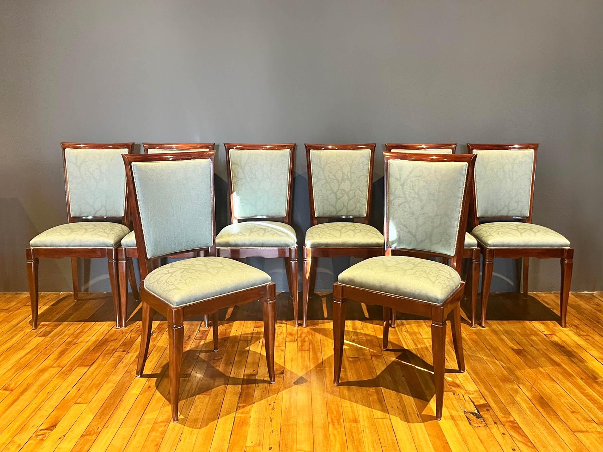 Elegant set of 8 Art Deco dining chairs in the style of Maurice Jallot, Jules Leleu and Jean Pascaud. The chairs boast solid wood frames with high backs and seats upholstered in green soft sheen jacquard fabric. 

2 matching dining room armchairs