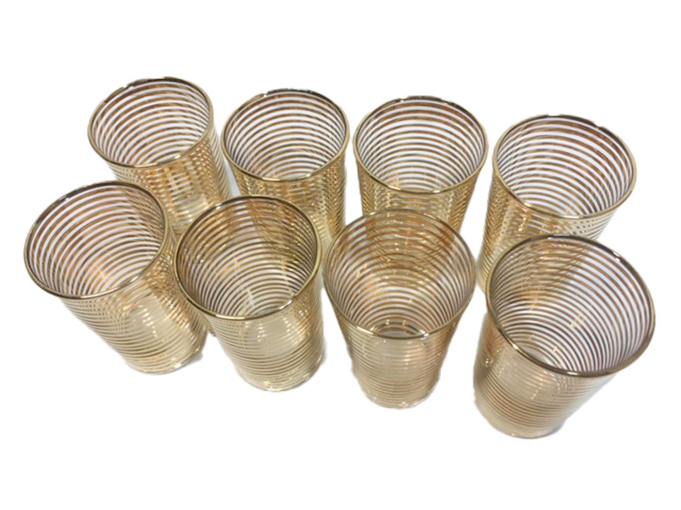 Eight vintage cocktail glasses with alternating gold and clear bands.
