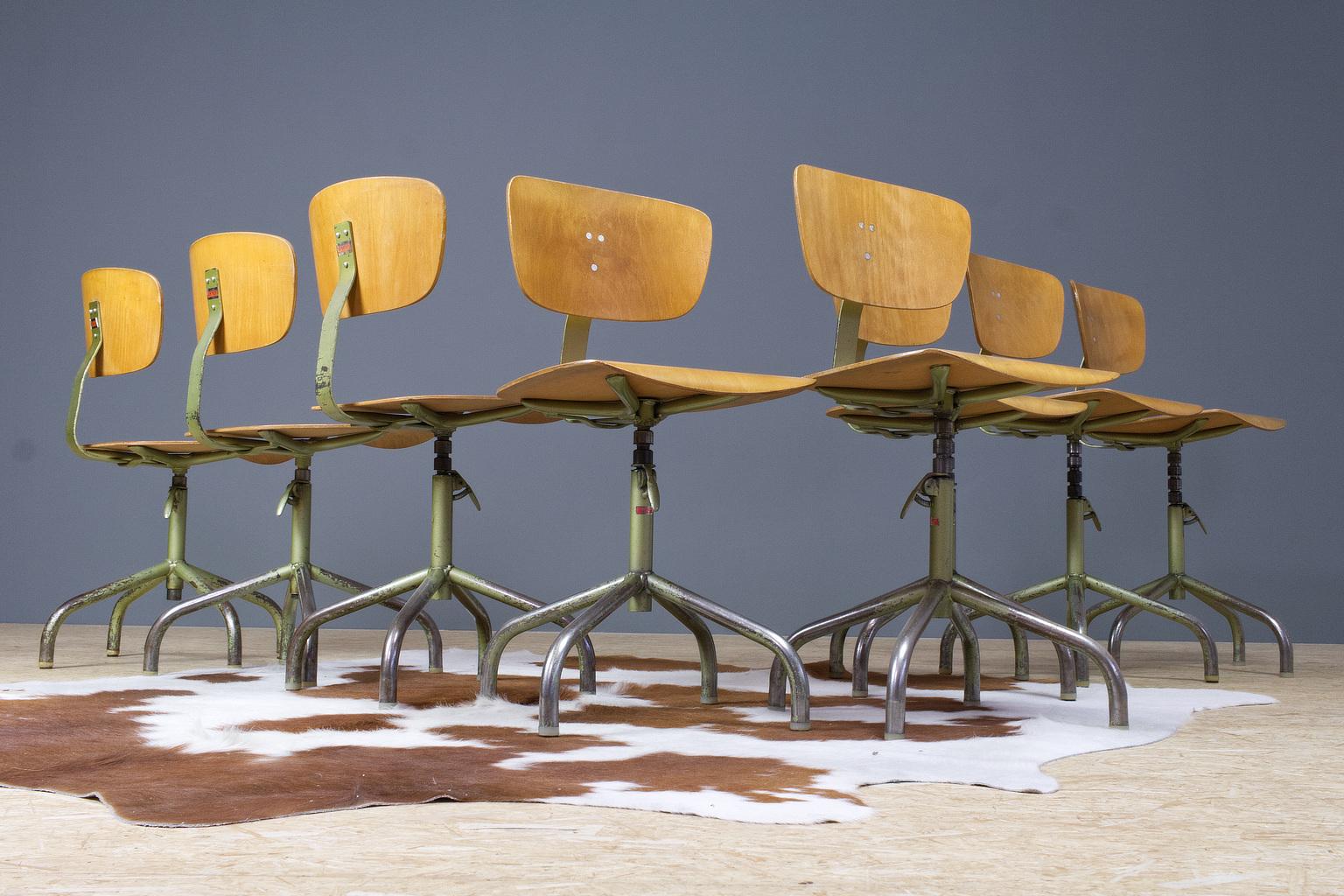 A set of 8 desk swivel chairs in metal an plywood, labelled 'Walter', Germany 1960s. The height is adjustable with an easy lever. Nice patina through use on the metal frames and legs as shown on photos. The green metal frame and plywood are in very