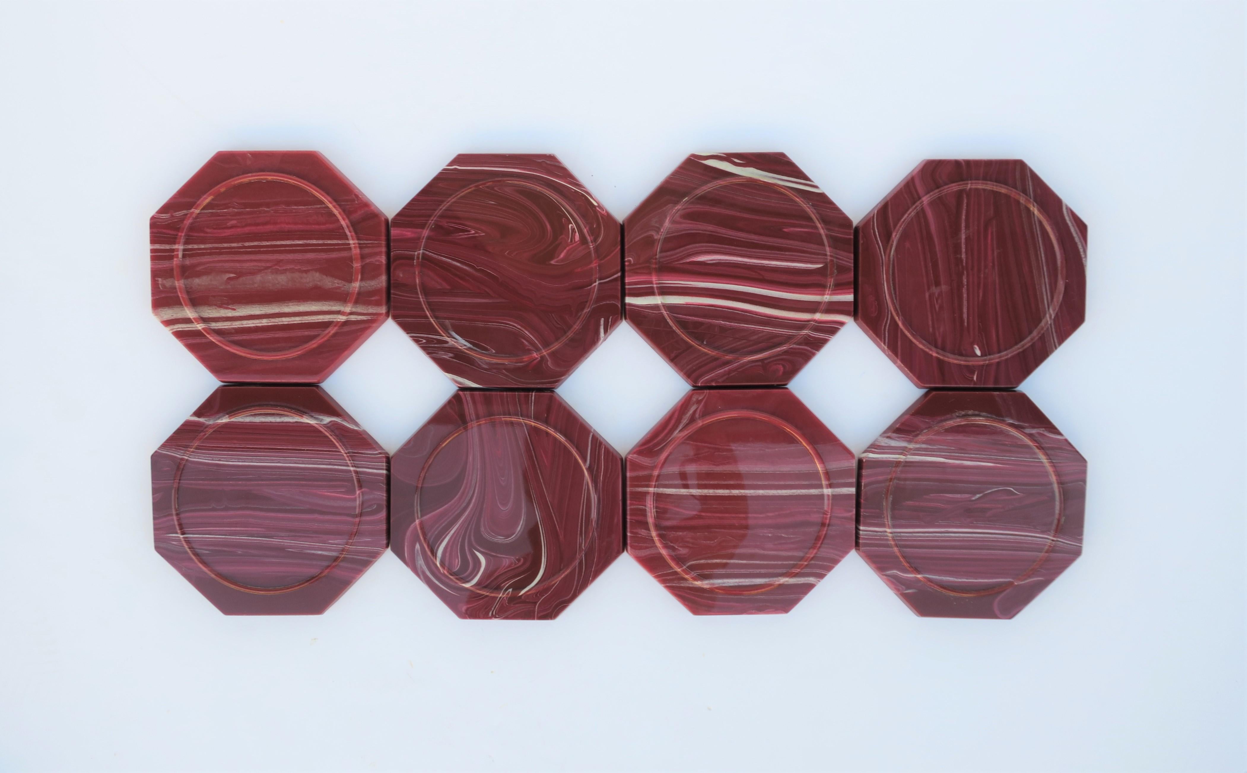 A chic set of 8 vintage onyx marble style octagonal acrylic/resin wine or cocktail coasters, circa 1970s. Coaters are resin/acrylic with a design style that resembles onyx or agate marble stone. Colors include a red burgundy/aubergine/maroon and