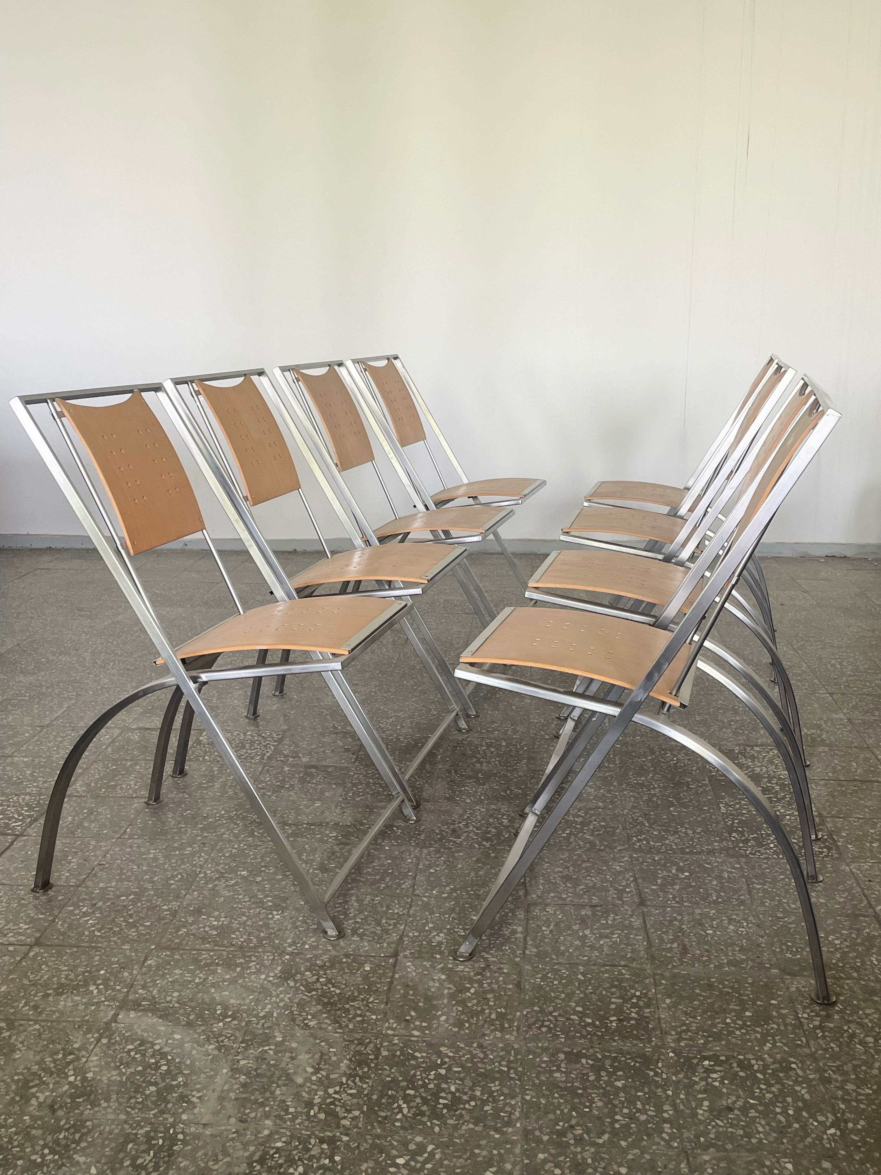  Rare set  of 8 brushed steel and plywood stackable dining chairs designed by Karl Friedrich Förster for KFF .In the 1980s, the company likely offered dining chairs with clean lines, sleek shapes, and minimalist aesthetics that were popular during