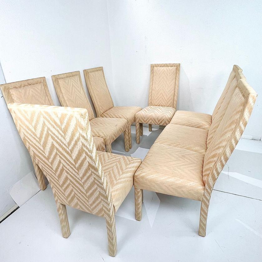 Sleek set of 8 high back Parsons style dining chairs in original chevron fabric. Upholstery shows some wear/staining due to normal age and use; Reupholstery is recommended. In the style of Milo Baughman.
