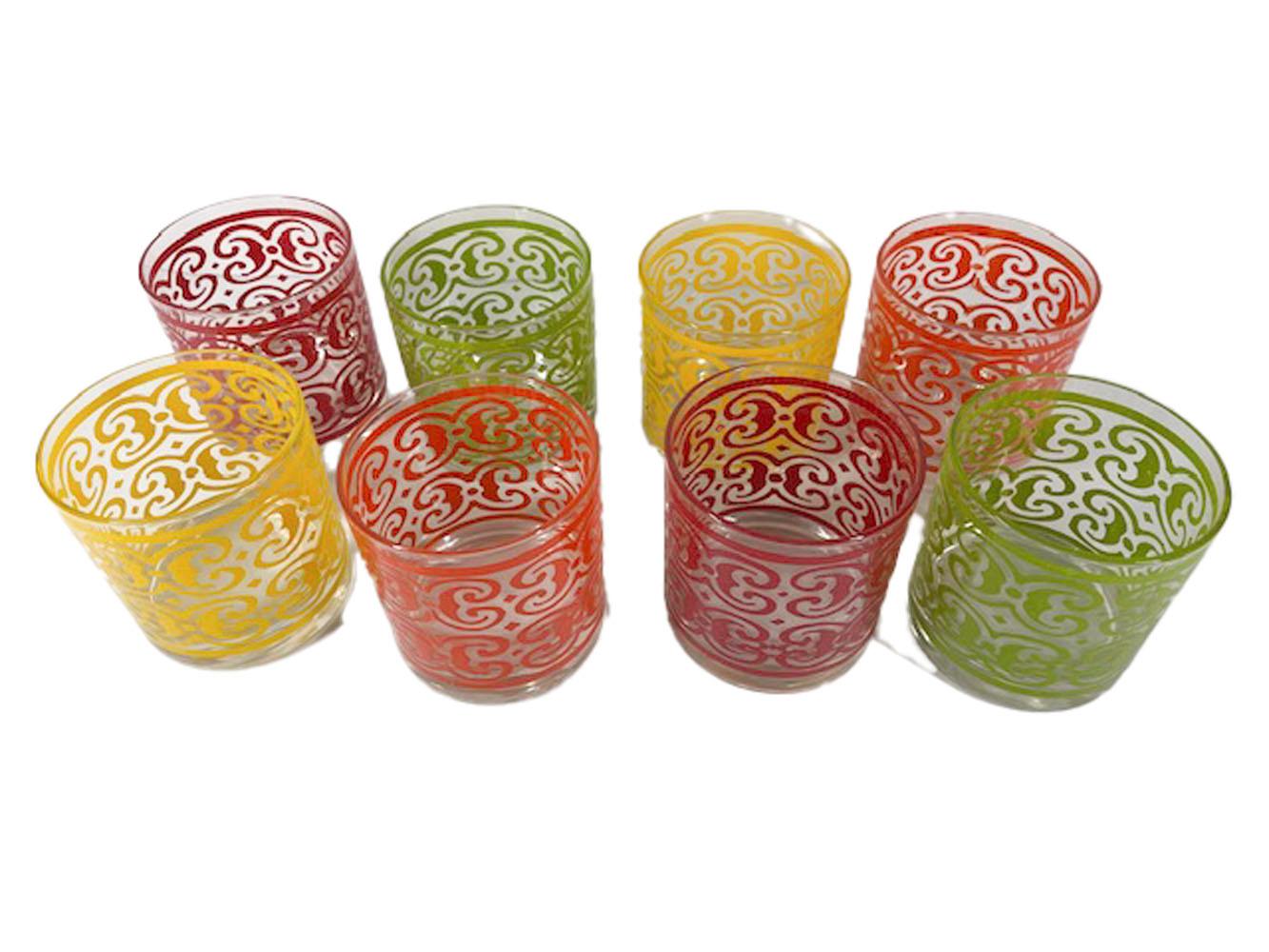 Mid-century set of 8 rocks glasses by West Virginia Glass Company in the Castile pattern. Raised textured enamel scrolls in two each of four colors Yellow, red, green and orange complete the set.