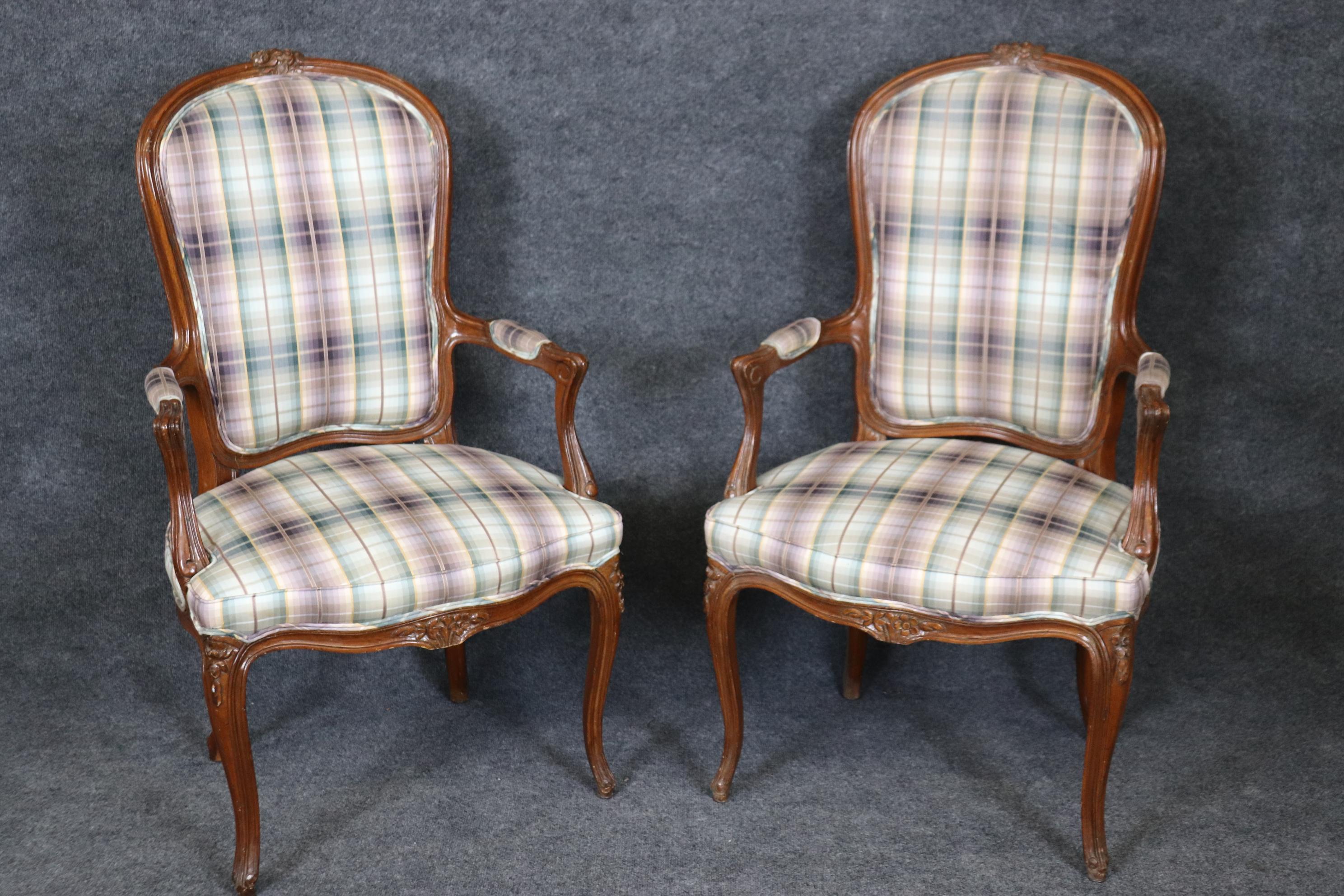  This is gorgeous set of cane back and two upholstered back dining chairs with carved walnut frames and plaid upholstery in pastel tones in good condition. These are cane chairs so please expect small holes and frays to cane here or there. The