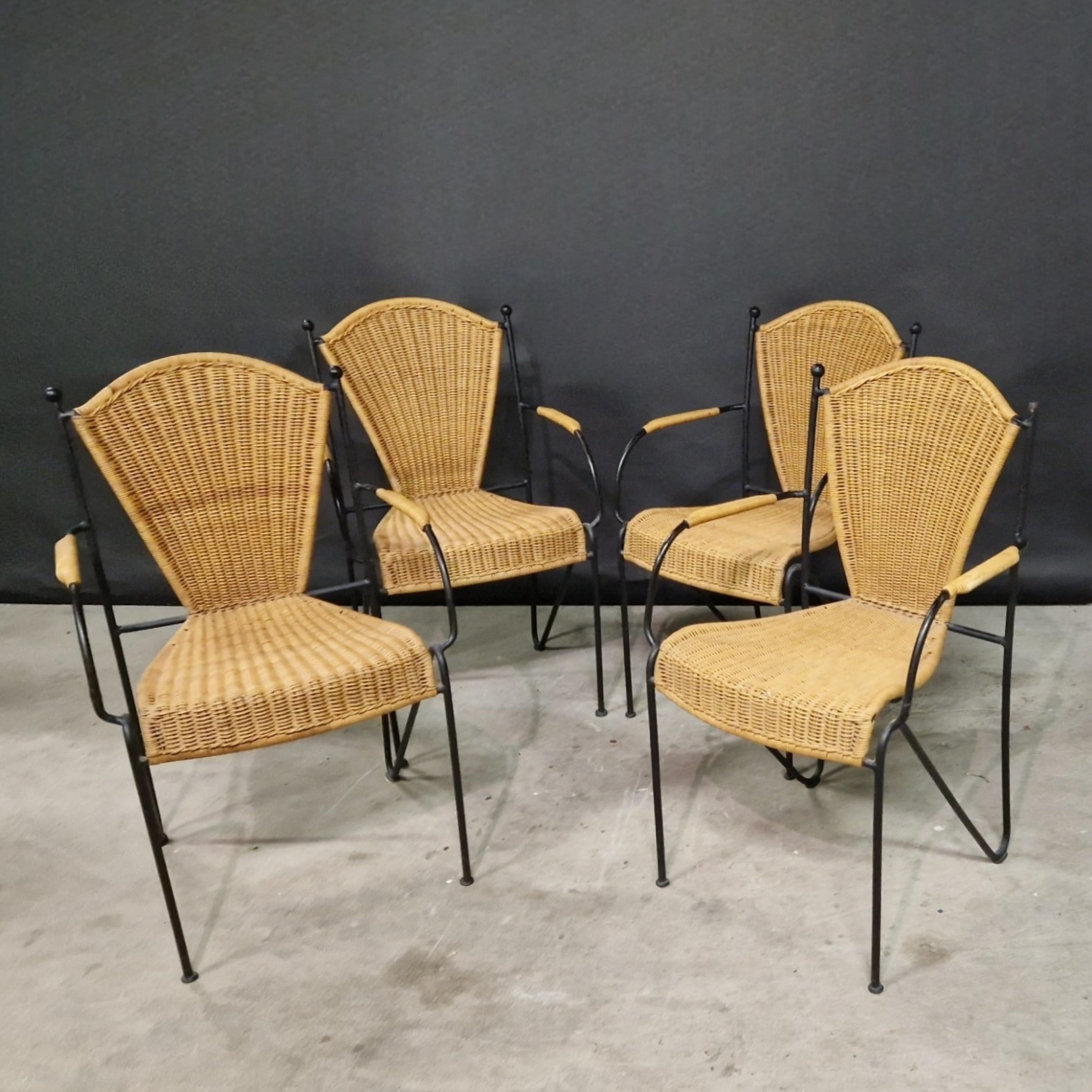Set of 8 French dining chairs. The frames are made from solid wrought iron and the seats are made from wicker. Handcrafted in the 1960s and still in an amazing condition, Heavy quality made pieces. Stackable.  These can be used outside as well as