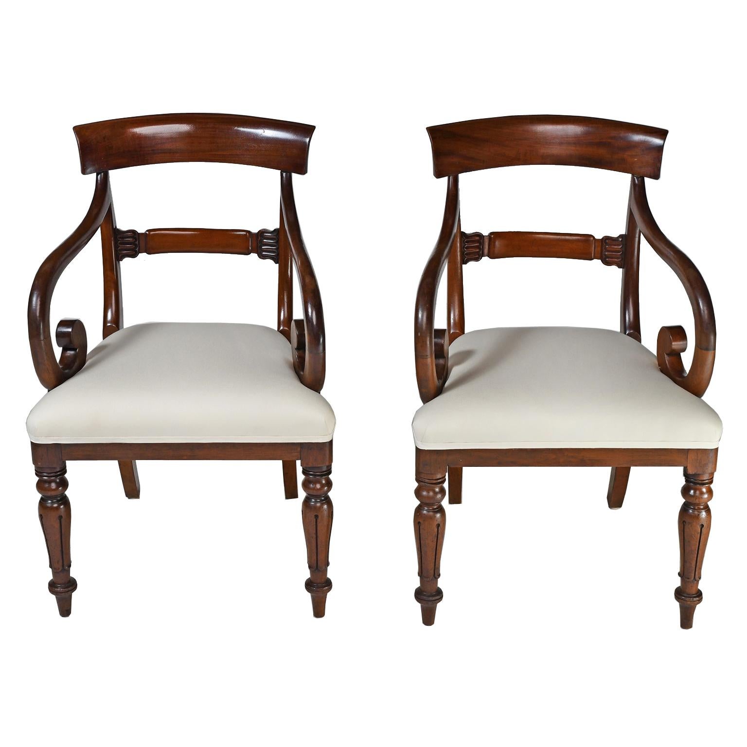 An exceptional set of eight (8) English William IV dining chairs in mahogany, comprising of 2 armchairs and 6 side chairs,  England, circa 1835. Chair design features a higher back than is usual for the time period with concave top rail, carved