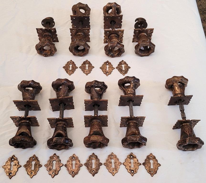 Presenting a gorgeous and unique set of 9 Art Nouveau hand beaten bronze door handles with plates.

Amazingly complete set!

Probably made in the US circa 1910 and most definitely influenced by the English New Lyn School of Arts and Crafts Era