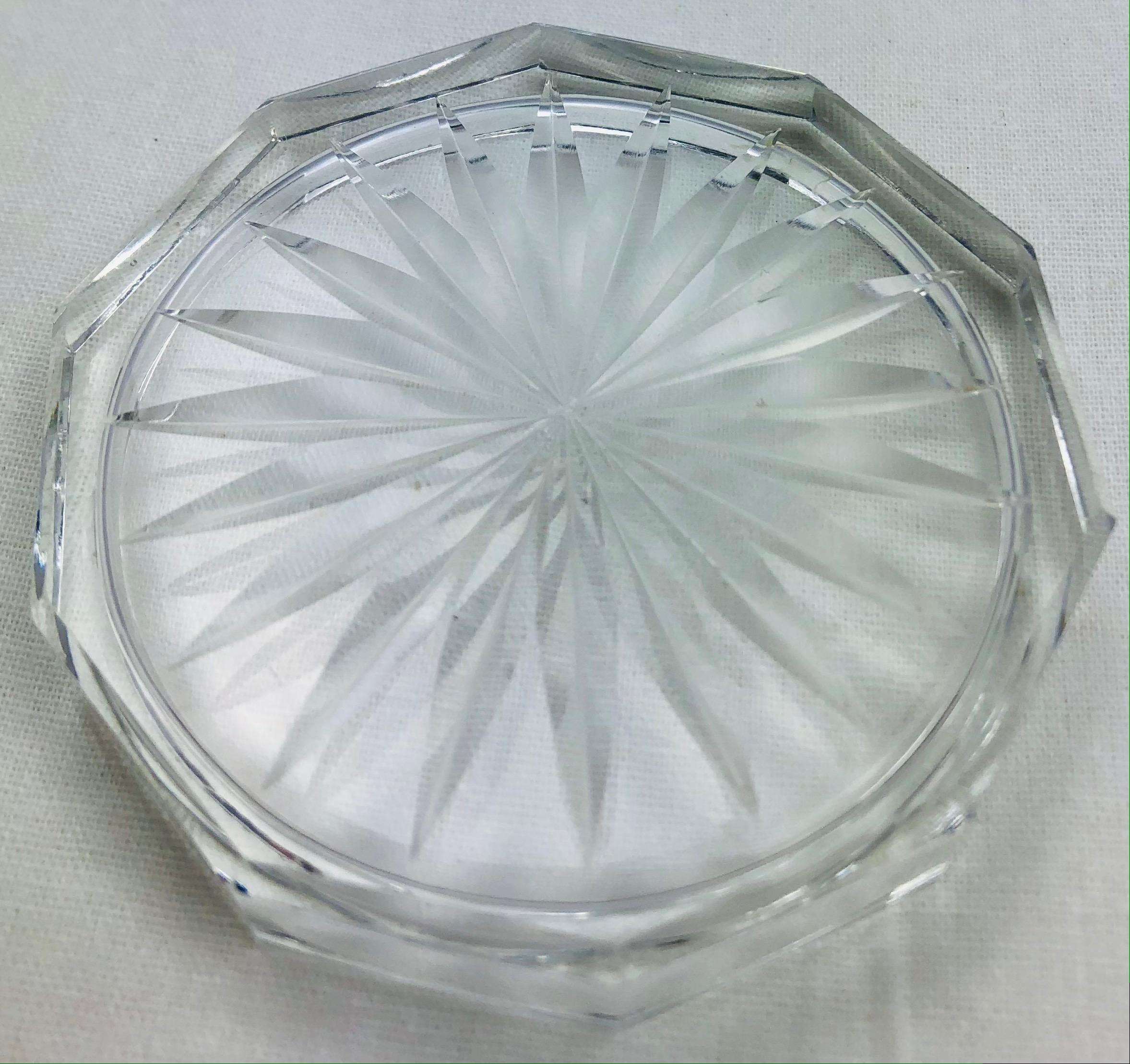 Beautiful set of 9 vintage French crystal wine or champagne coasters, attributed to Baccarat. Lovely table accessories with a mixture of straight sharp cuts and smooth round curves, reminiscent of a rose. The most important aspect of this collection