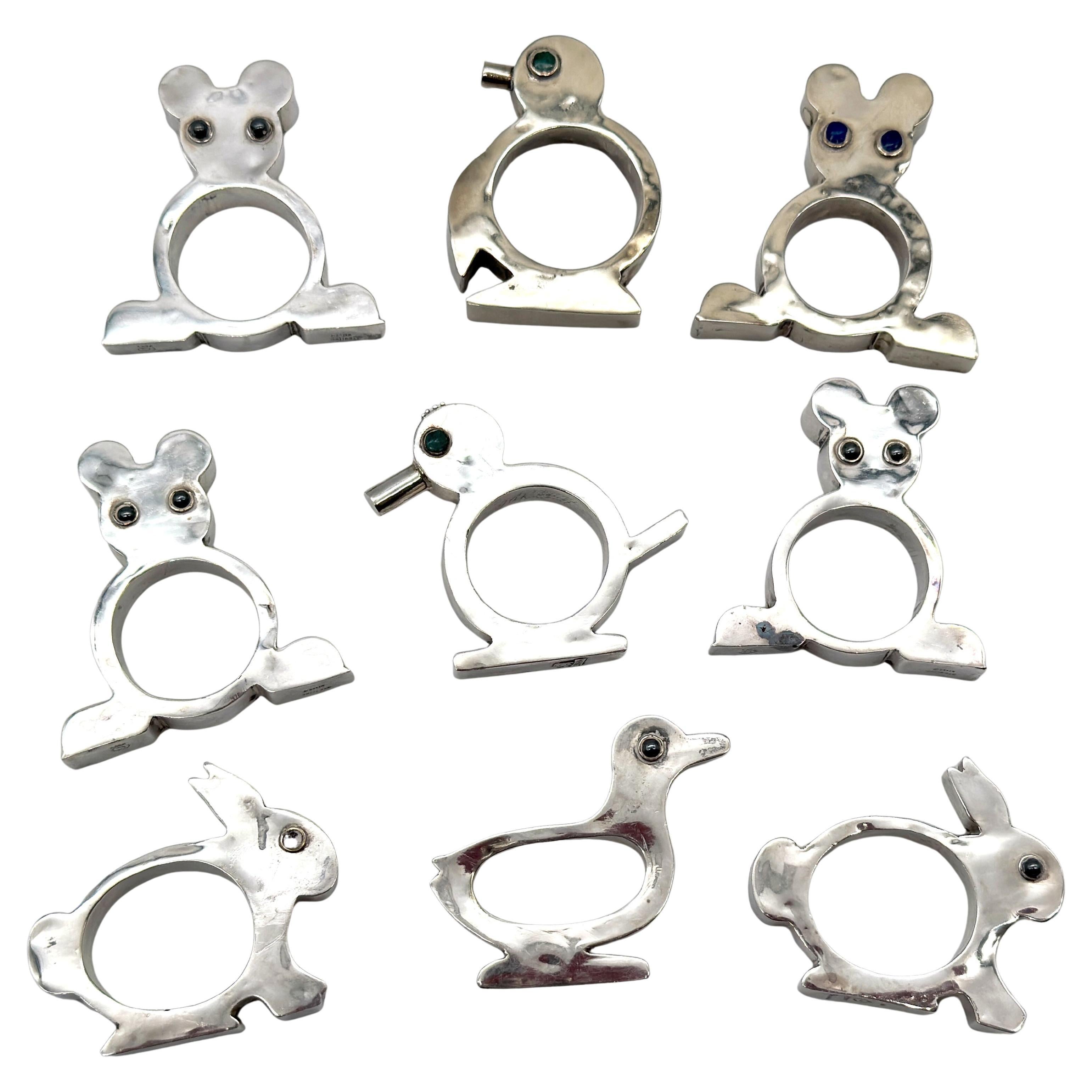 Set of 9 Figural Sterling Silver Napkin Rings, Taxco School, Mexico, Mid-20th C.