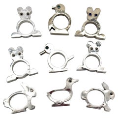 Set of 9 Figural Sterling Silver Napkin Rings, Taxco School, Mexico, Mid-20th C.