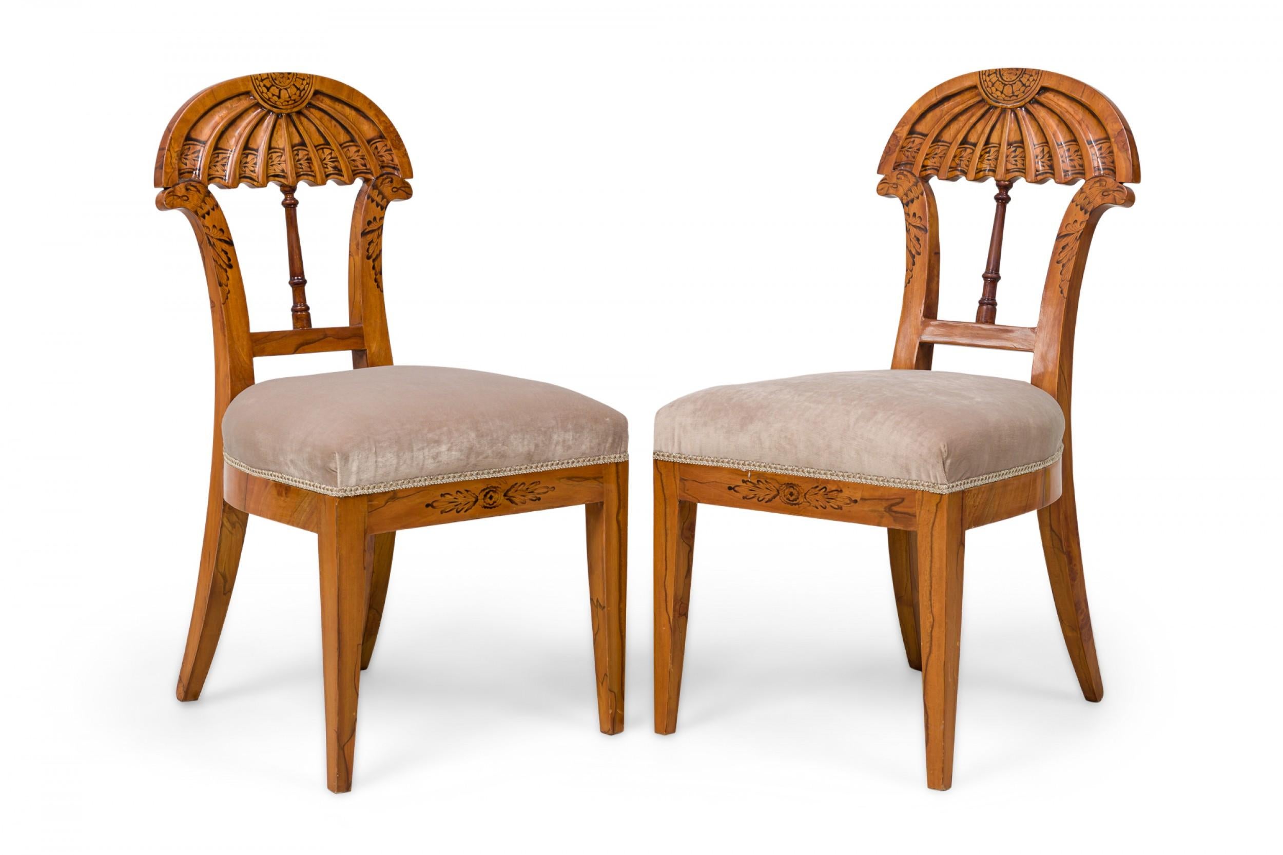SET of 9 Biedermeier Viennese (19th Century) dining / side chairs featuring carved arch backs in fluted form and bird\'s head supports decorated with polychrome embellishments, a balustrade center stretcher, with seats upholstered in pastel velvet