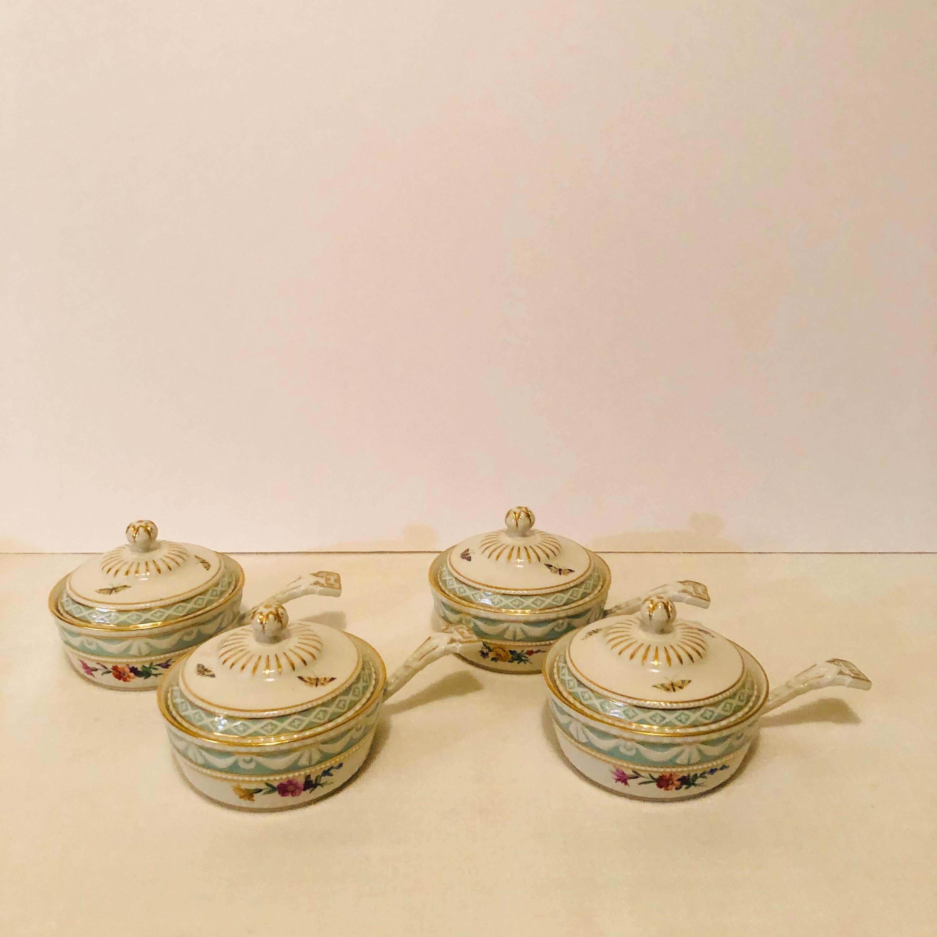I would like to offer you this rare set of nine KPM pot de creme in the Kirkland pattern. Each pot de creme is painted with different flowers and different butterflies. They each have an aqua bottom with raised white ribbon decoration next to their