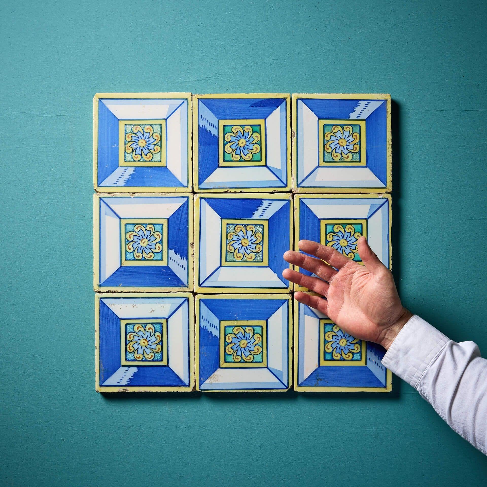 A collection of 6-inch reclaimed geometric polychrome tiles consisting of 9 glazed clay tiles decorated in striking blue and yellow tones. Vibrant and eye-catching, these spectacular antique tiles are supplied loose and could be arranged in any