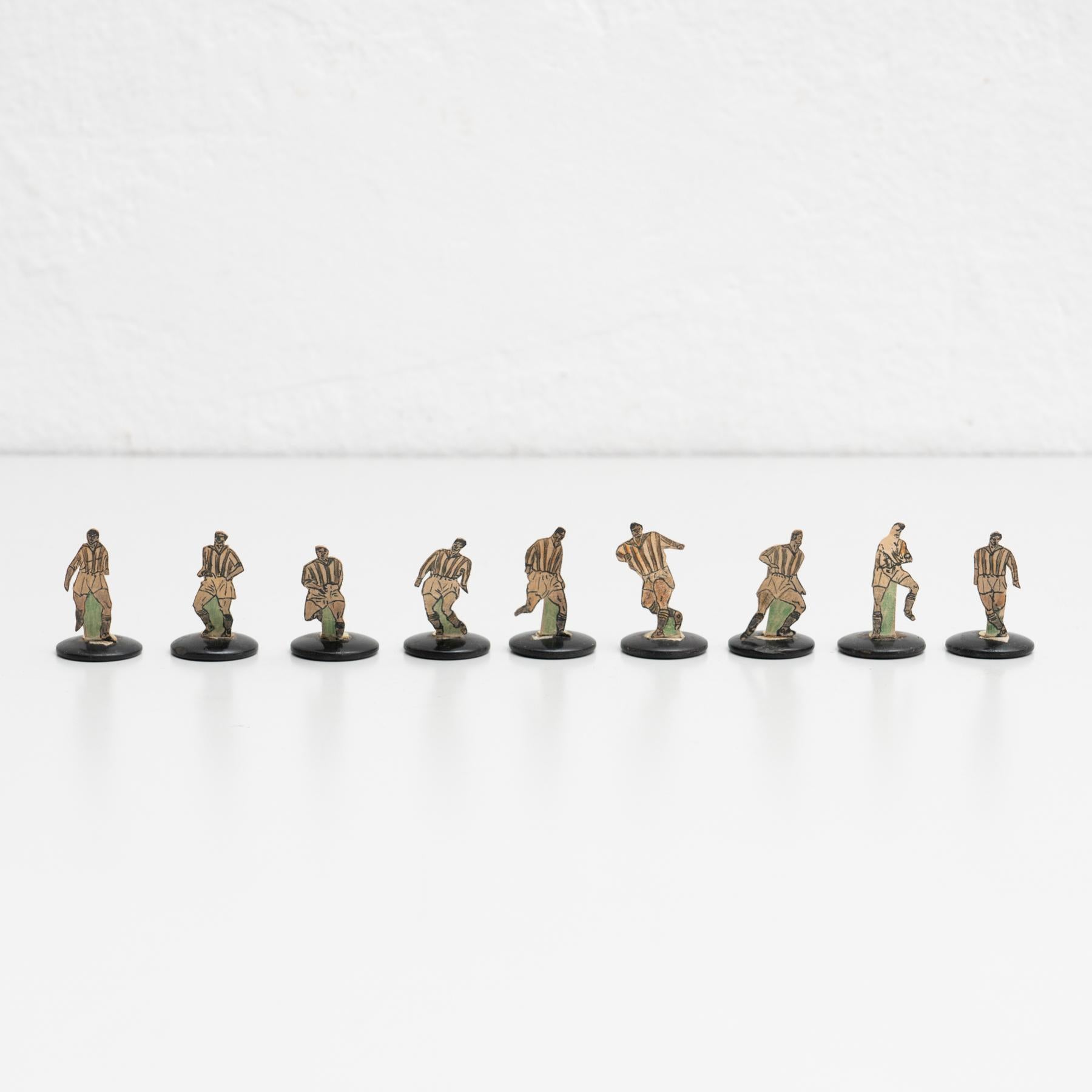 Set of nine table button soccer game players. Traditional figures used to play this classic button Spanish game. 

The players are build buy attaching a printed photography or drawing of an actual football soccer player to a clothing button.