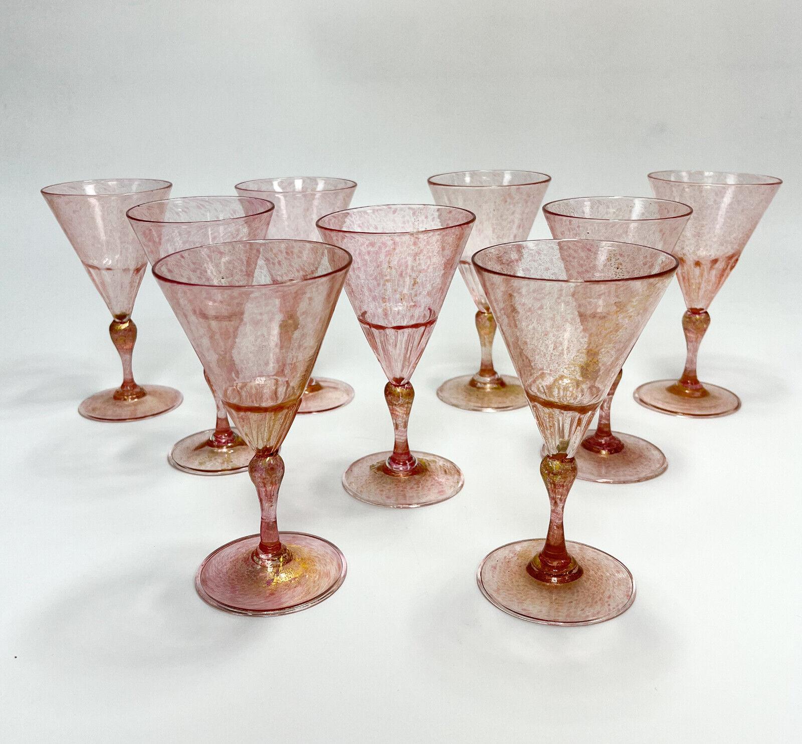 Set of 9 Venetian cranberry art glass and gold fleck wine goblets.

Partially ribbed towards the bottom of the bowl that meets the stem. Pontil to the underside base.

Additional Information:
Type: Goblet 
Color: red and gold
Brand: Art Glass